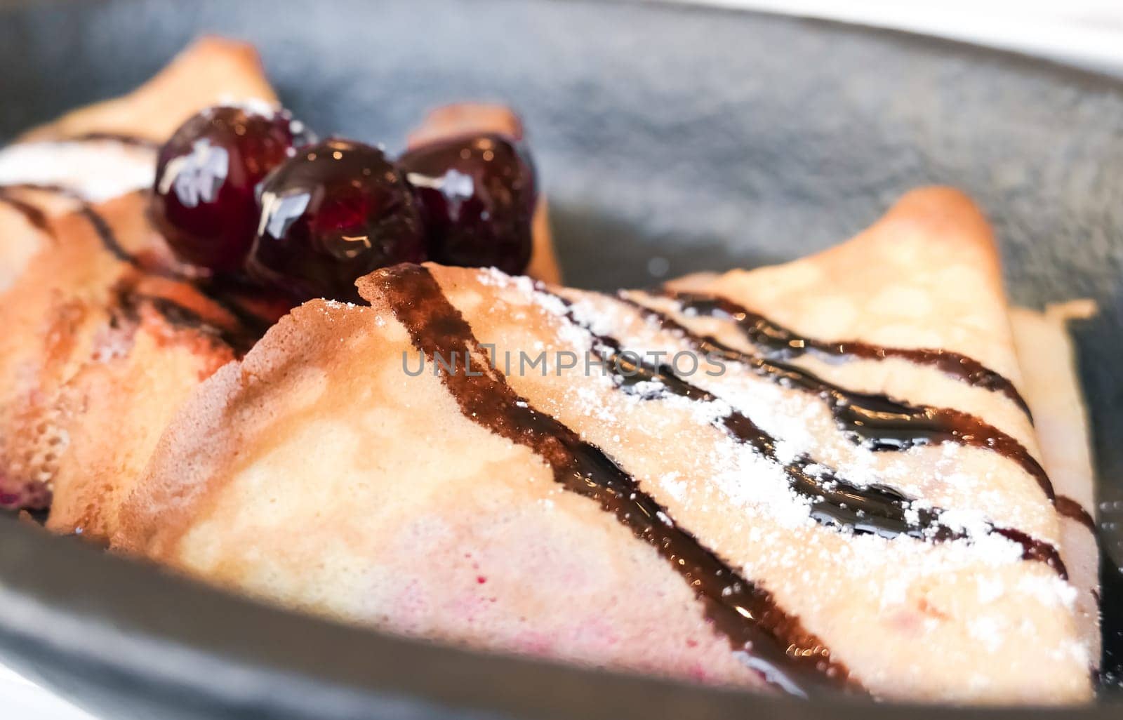 Sweet dessert, breakfast food and luxury service - French crepes with chocolate sauce and cherries in a reastaurant in Paris, pancakes recipe