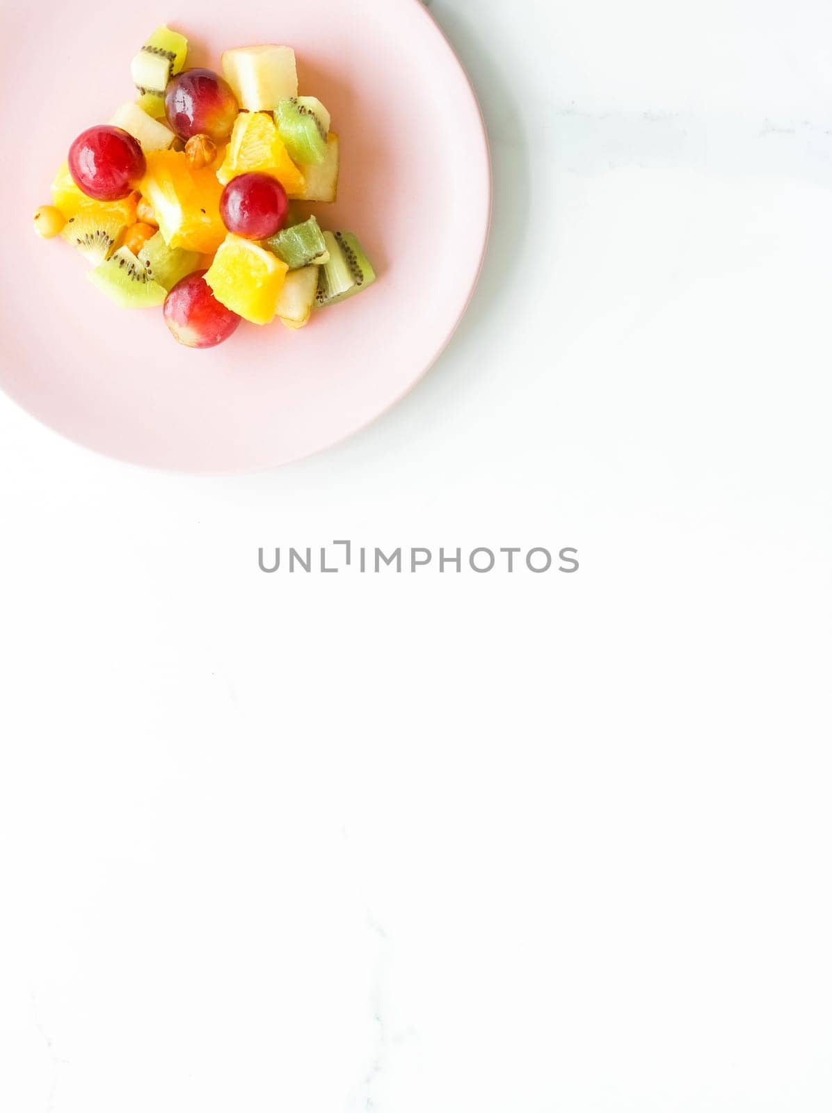 juicy fruit salad for breakfast on marble, flatlay - dieting and healthy lifestyle styled concept