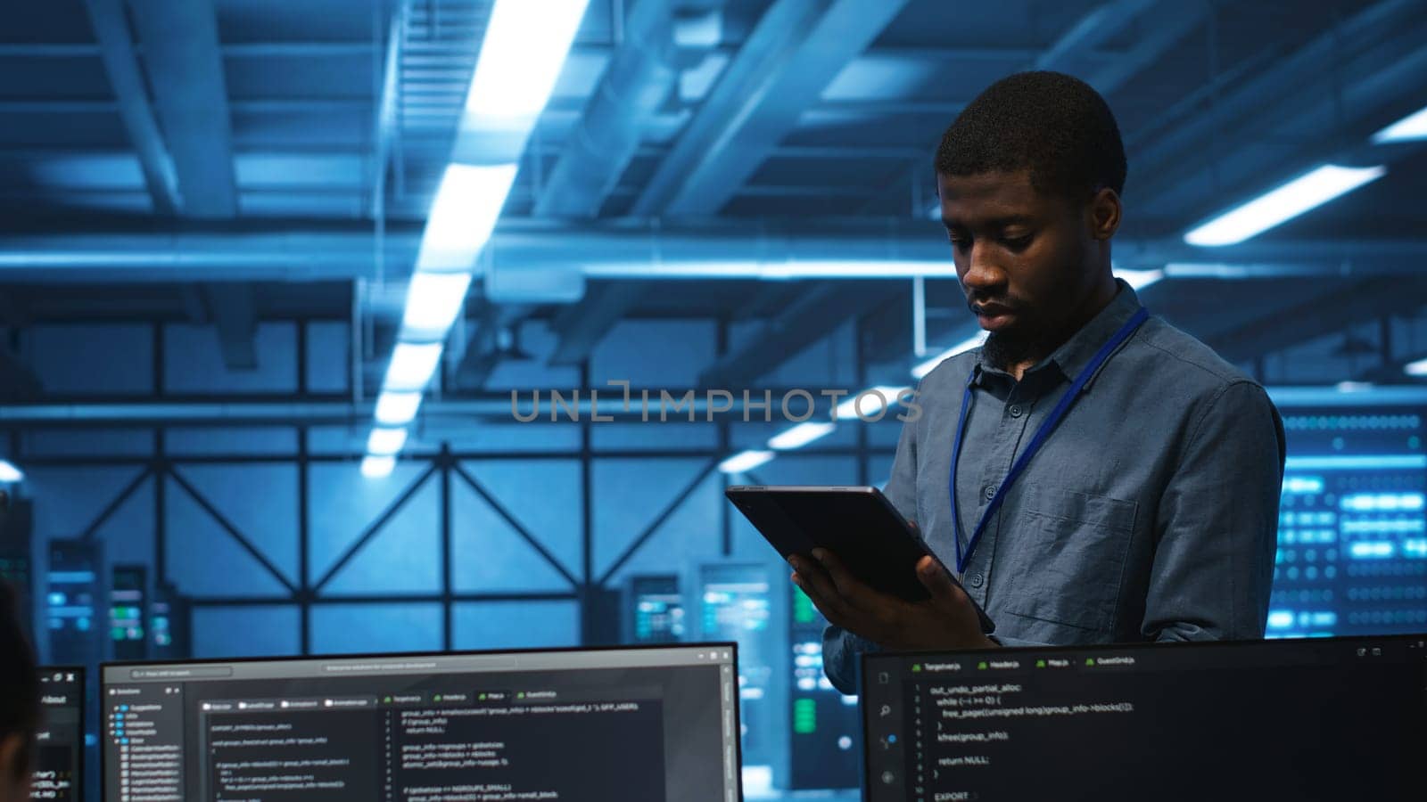 Technician in server hub using tablet to find hardware misconfigurations affecting rackmounts performance. Man checking data center infrastructure devices bottlenecks leading to errors