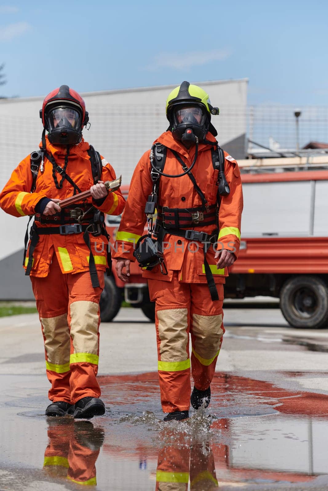 A team of confident and accomplished firefighters strides purposefully in their uniforms, exuding pride and satisfaction after successfully completing a challenging firefighting mission.