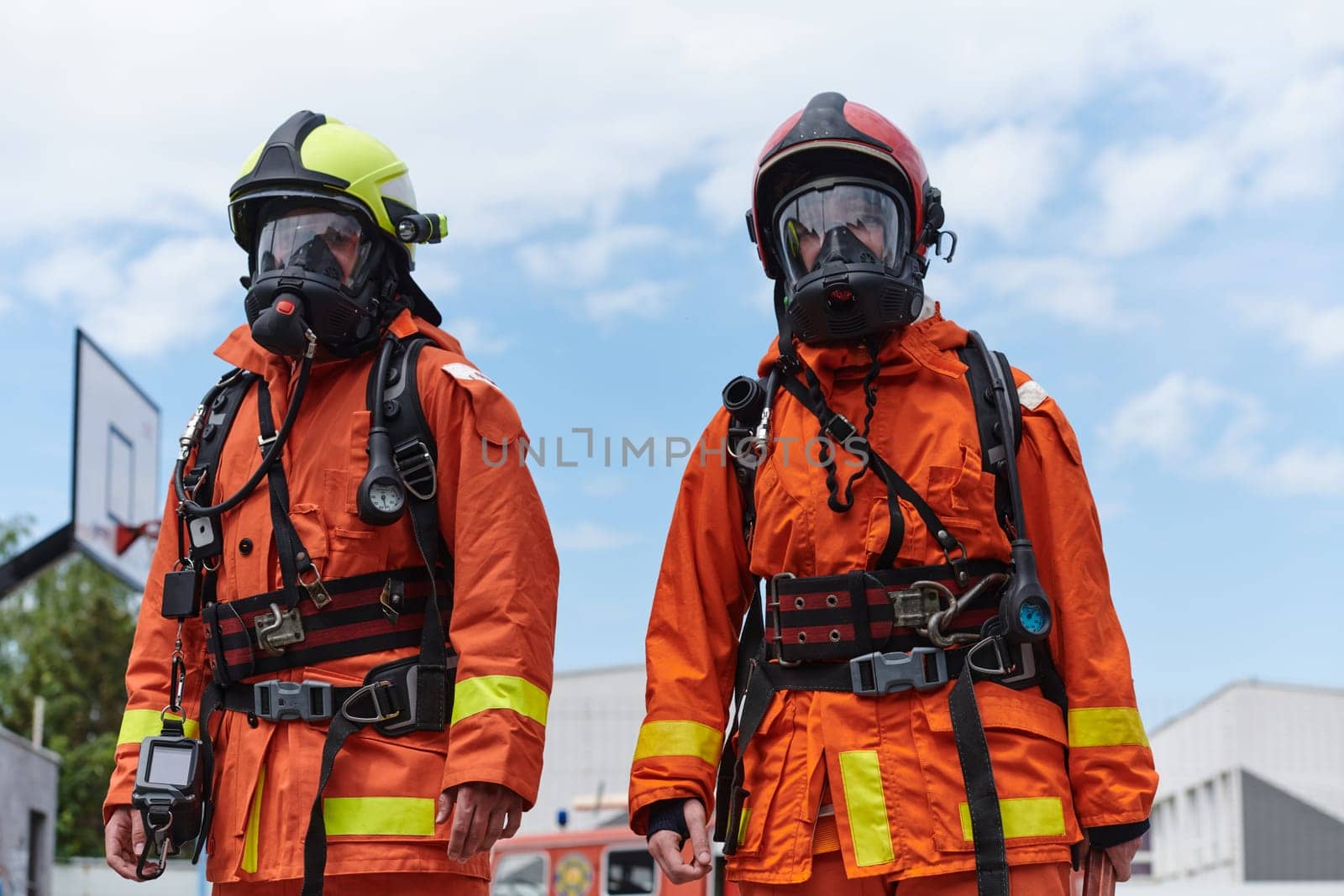 A team of firefighters, dressed in professional gear, undergoes training to learn how to use various firefighting tools and prepare for firefighting tasks.