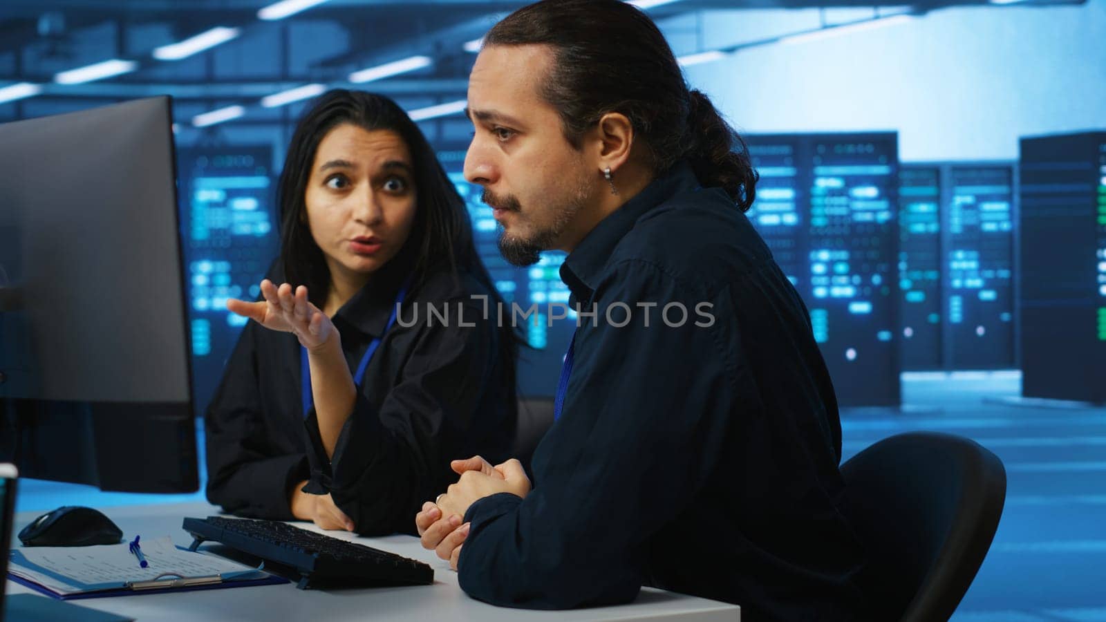 IT technicians in server farm brainstorming ways to repair equipment storing datasets. Colleagues at work in data center discussing how to mend rigs doing computational operations