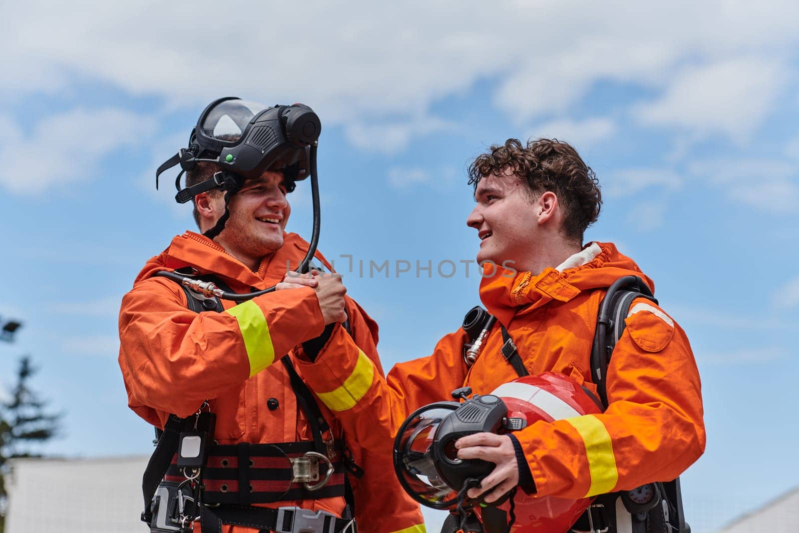 A unified team of firefighters, adorned in their uniforms, engages in a heartfelt celebration marked by triumphant salutes and cheers, embodying the joy and gratitude following the successful completion of a challenging firefighting mission.