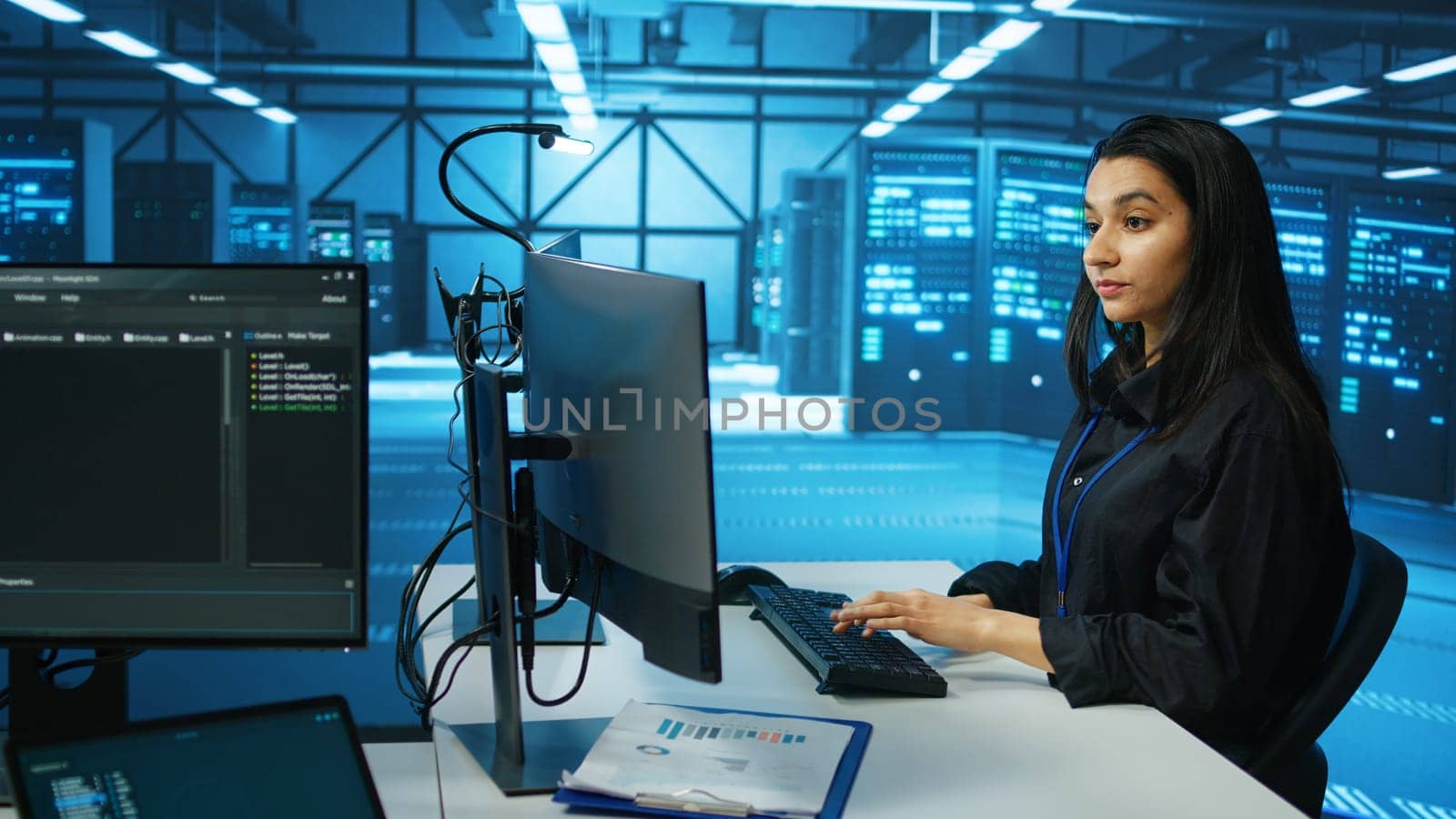 IT engineer in data center using PC to find misconfigurations affecting rackmounts performance. Woman checking servers bottlenecks leading to sluggish data transfer rates and malfunctions
