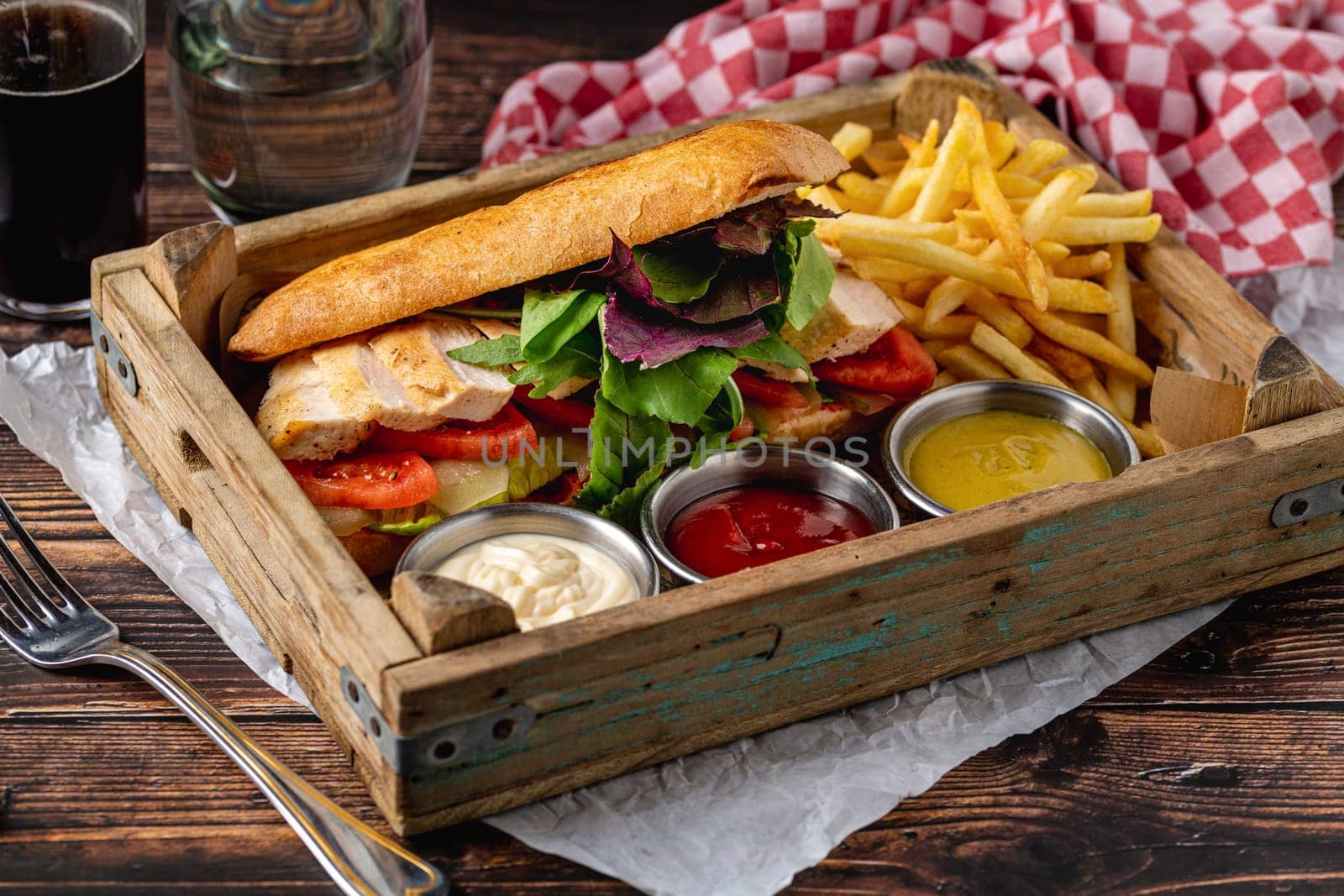 Grilled chicken breast sandwich with french fries and sauces by Sonat