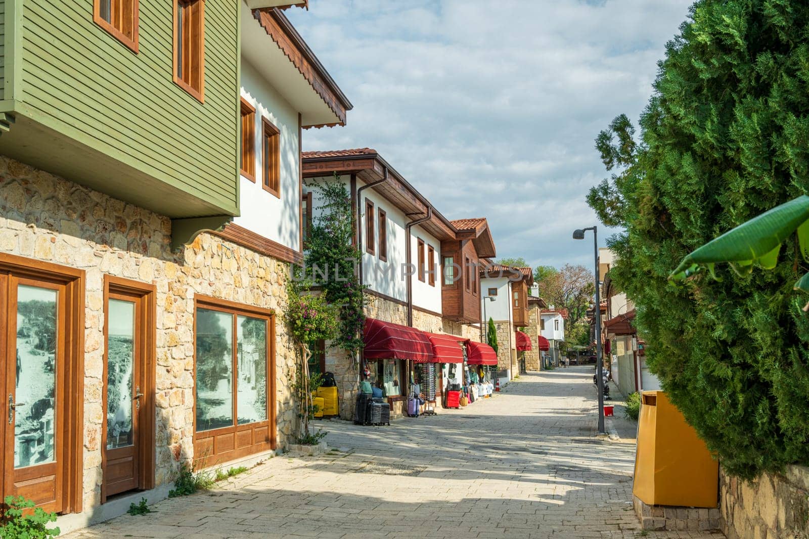 Restored houses with bay windows on the historical streets of Side Antalya by Sonat