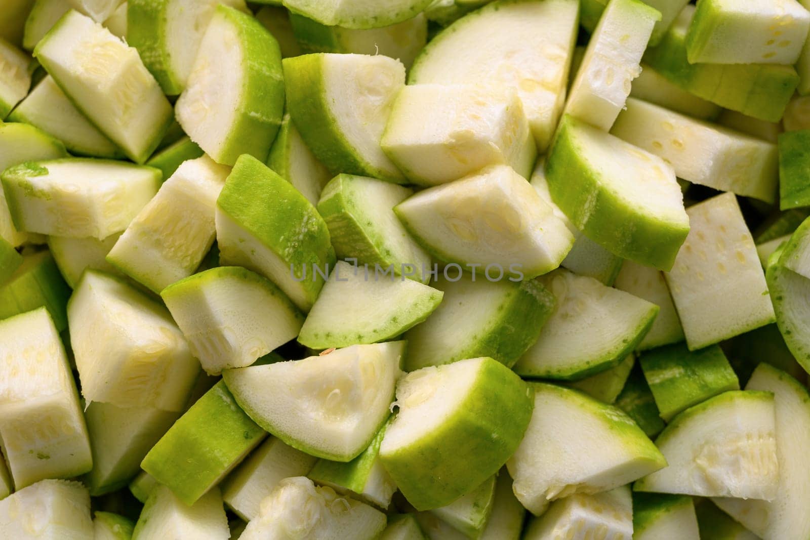 Top view of zucchine being diced for frying by Sonat