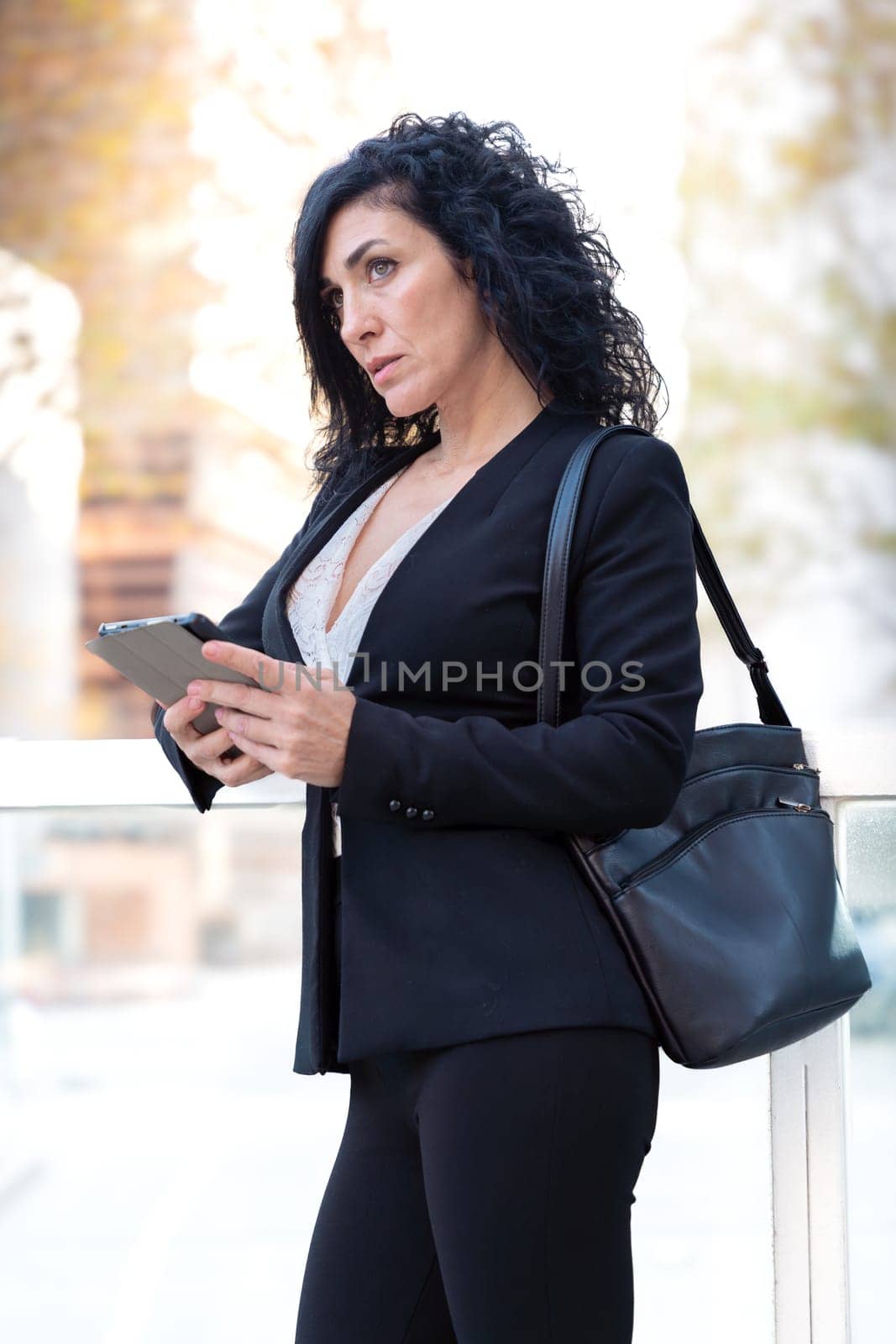 Middle Aged Caucasian Business Woman, Serious Standing With Digital Tablet In Hands