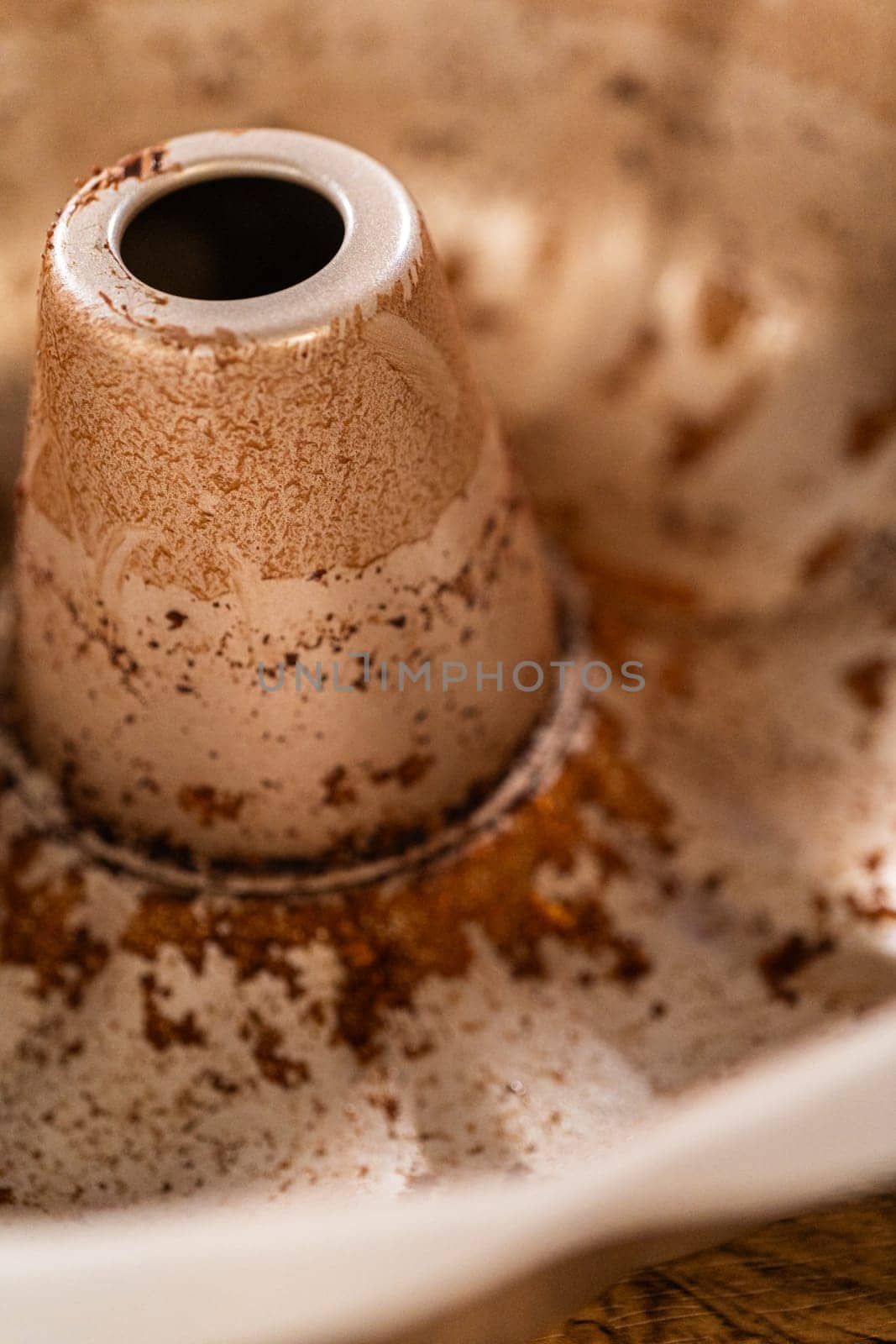 A close-up view of a dirty bundt cake pan after baking.