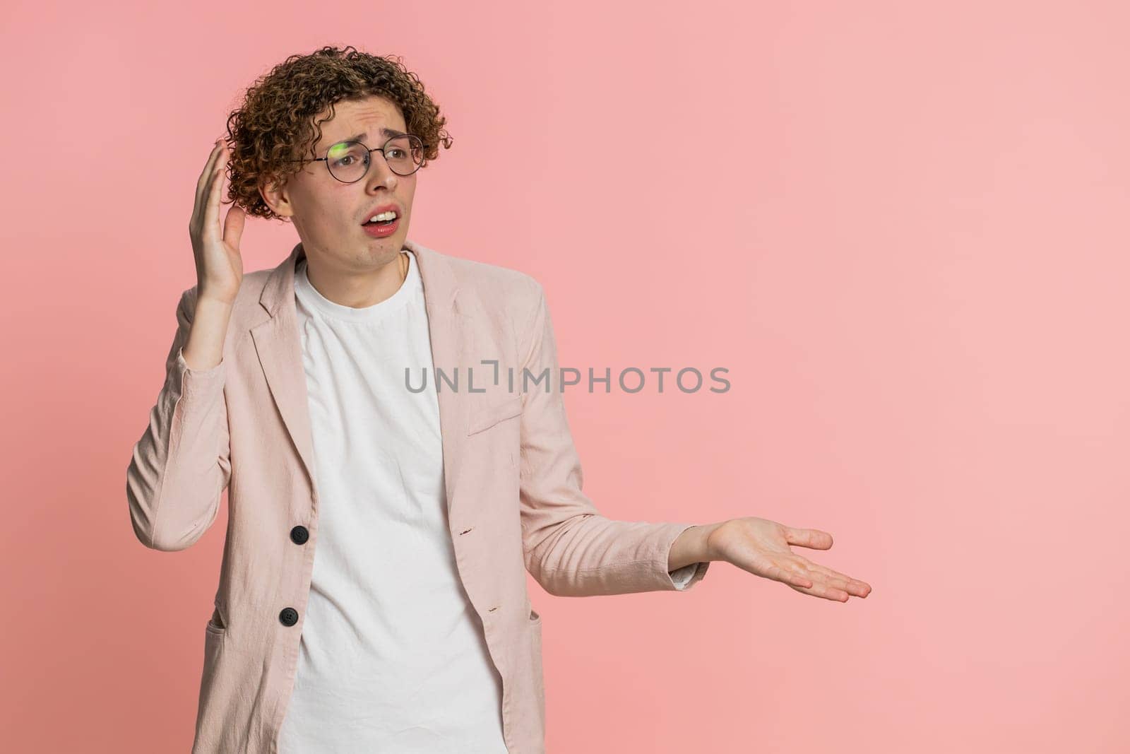 Sad young Caucasian man feeling hopelessness loneliness, nervous breakdown, loses becoming surprised by lottery results, bad fortune, loss unlucky news. Attractive guy isolated on pink background