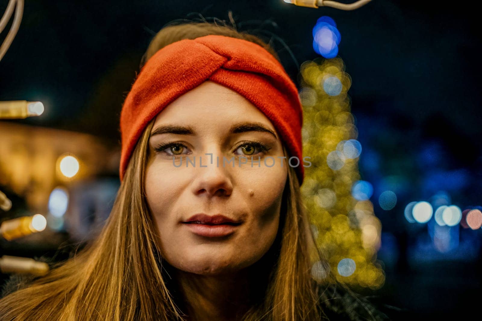 Winter fun on the street: Girl with sparklers, smiles in warm jacket and hat. Festive Christmas or New Year celebration,
