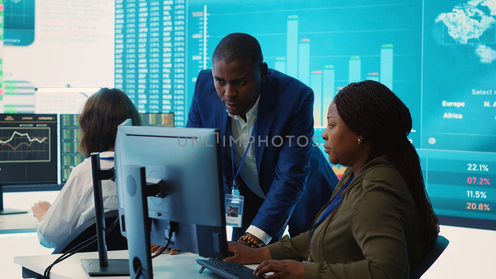 Financial analyst works on resource allocation plans with his staff by DCStudio