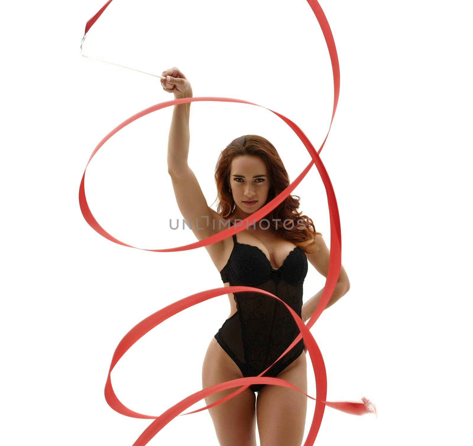 Sexy artistic gymnast posing with ribbon. Isolated on white background