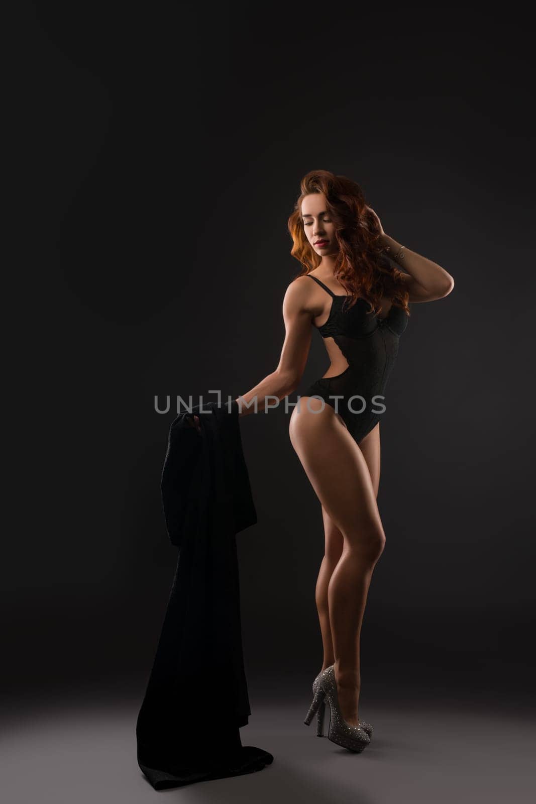 Studio image of sexy underwear model posing in high heels