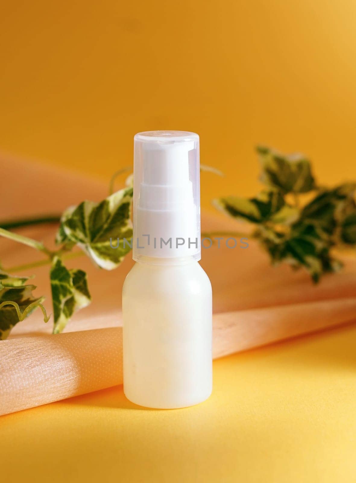 Unlabeled bottle of cosmetic or soap shower gel is displayed on an artistic background, product enclosure for liquid product for promotional and marketing purpose