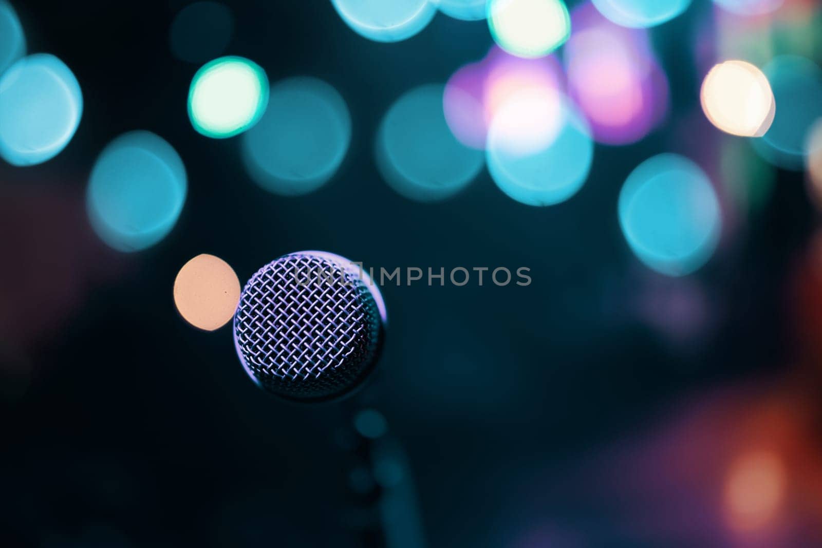 Microphone on colorful background. Stage and retro microphone.