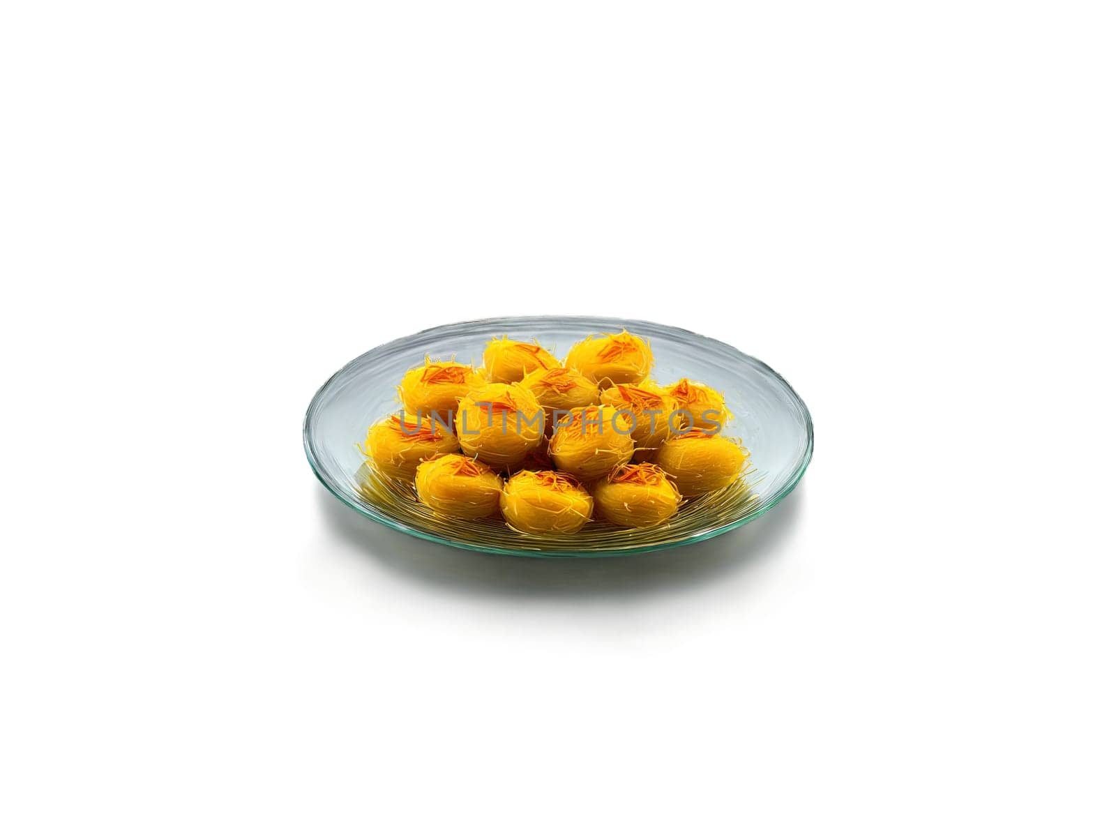 Peda with Saffron Small pedas with a hint of saffron arranged on a glass plate. Food isolated on transparent background.