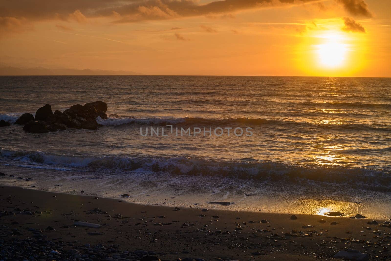 sunset on the sea - A sea wave breaks on a large stone with beautiful white splashes.1 by Mixa74