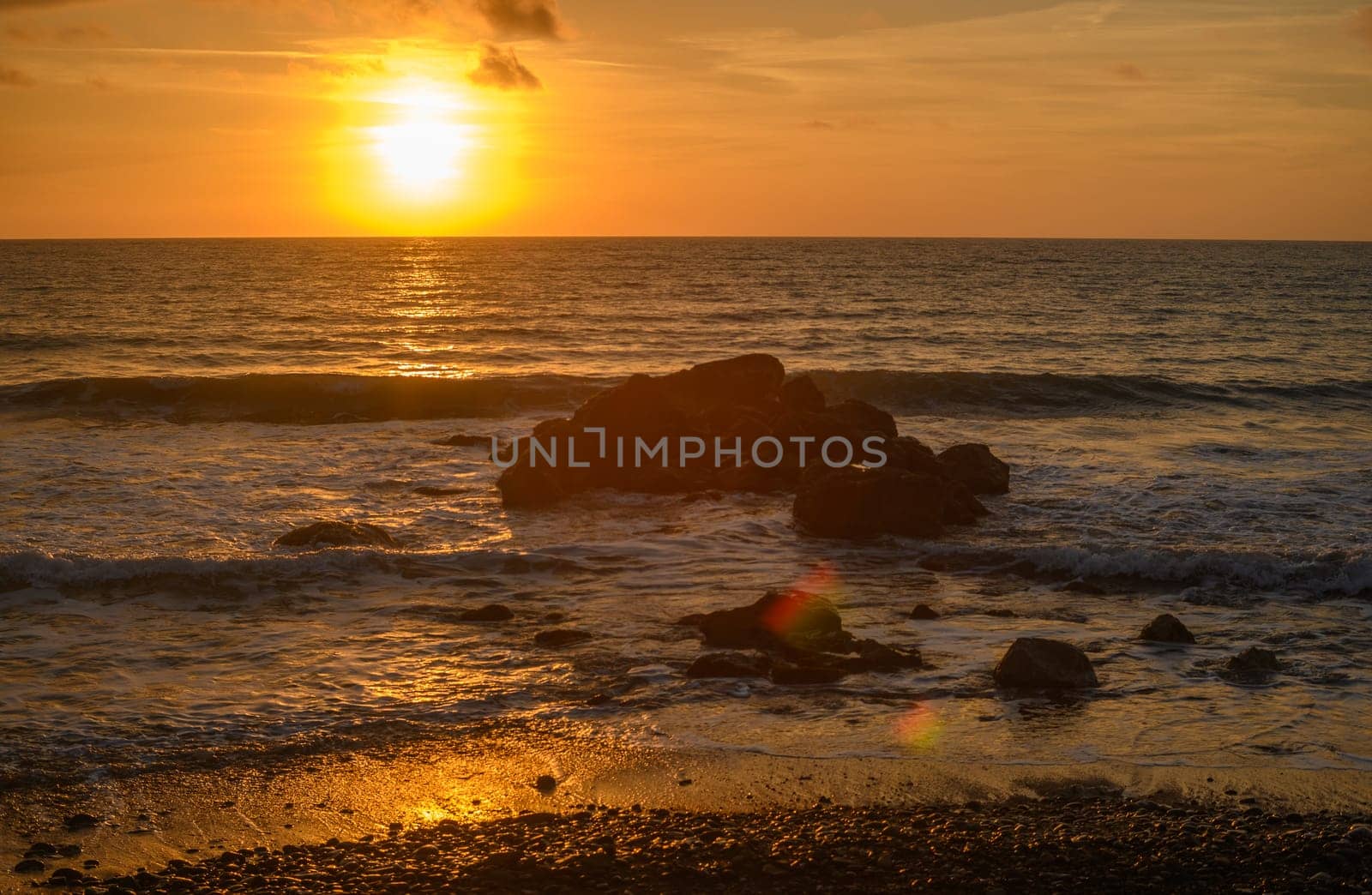 Beach stones in the background of the sunset in the Mediterranean Sea 3