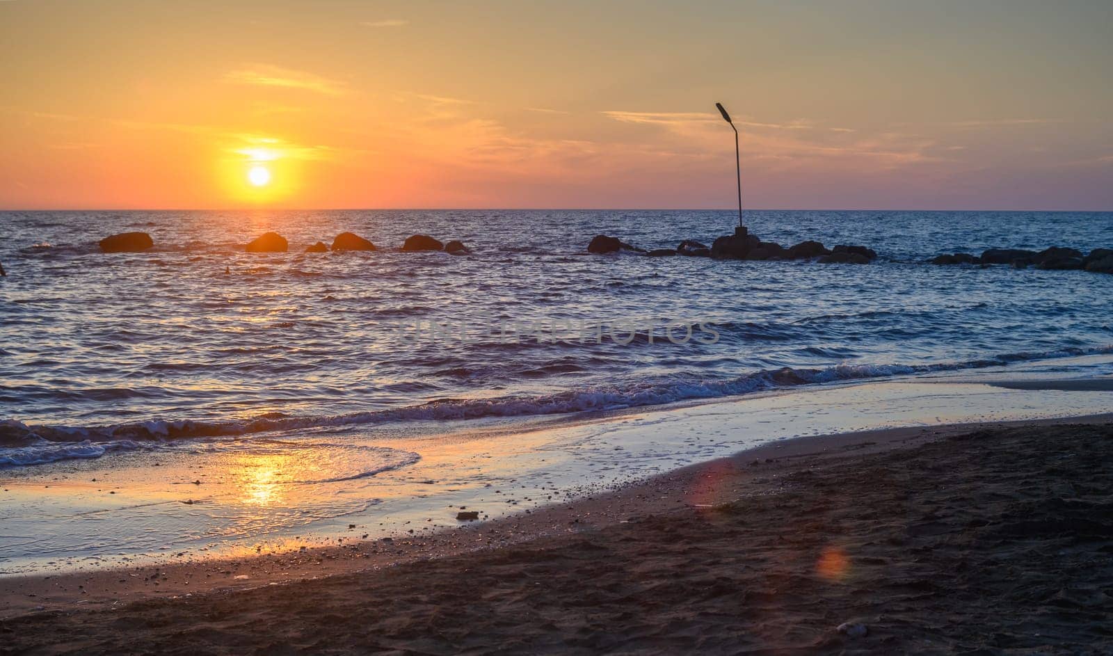 Sunset on pebble beach with sea waves of mediterranean sea 1 by Mixa74