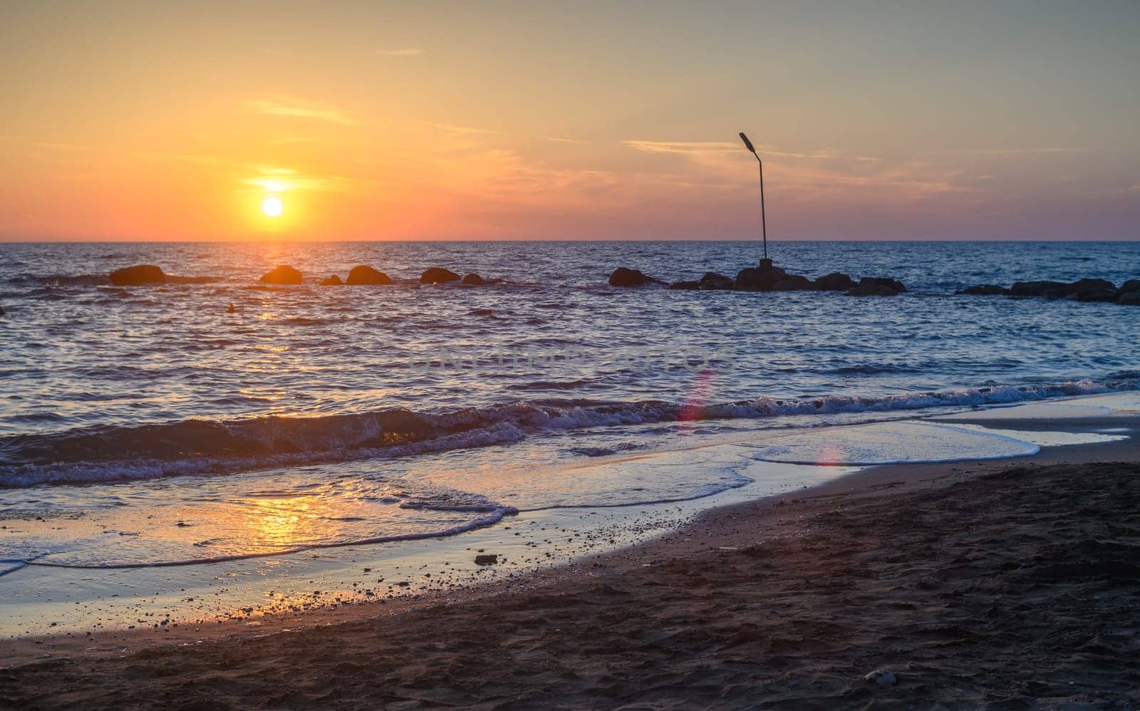 Sunset on pebble beach with sea waves of mediterranean sea 3