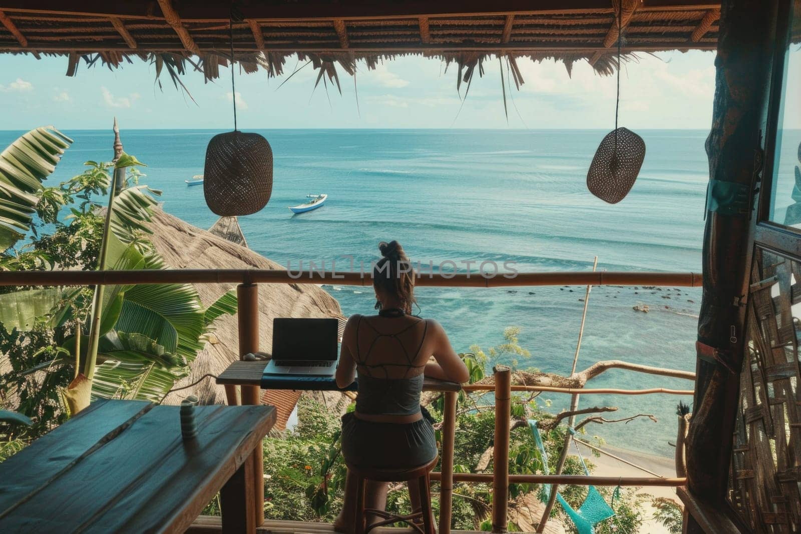 Woman sitting at table with laptop in front of ocean view, inspirational remote work environment with travel vibes by Vichizh