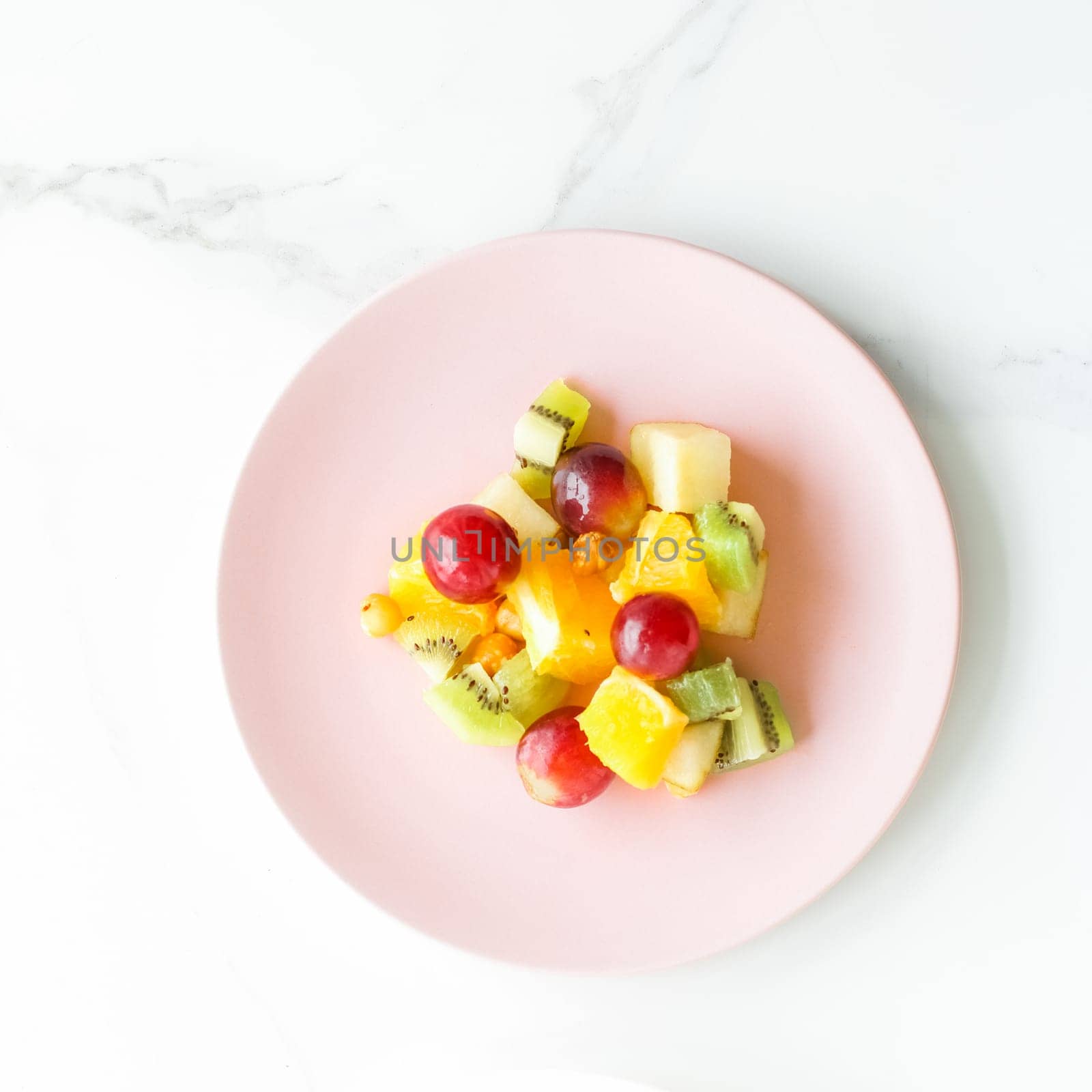 juicy fruit salad for breakfast on marble, flatlay - dieting and healthy lifestyle styled concept