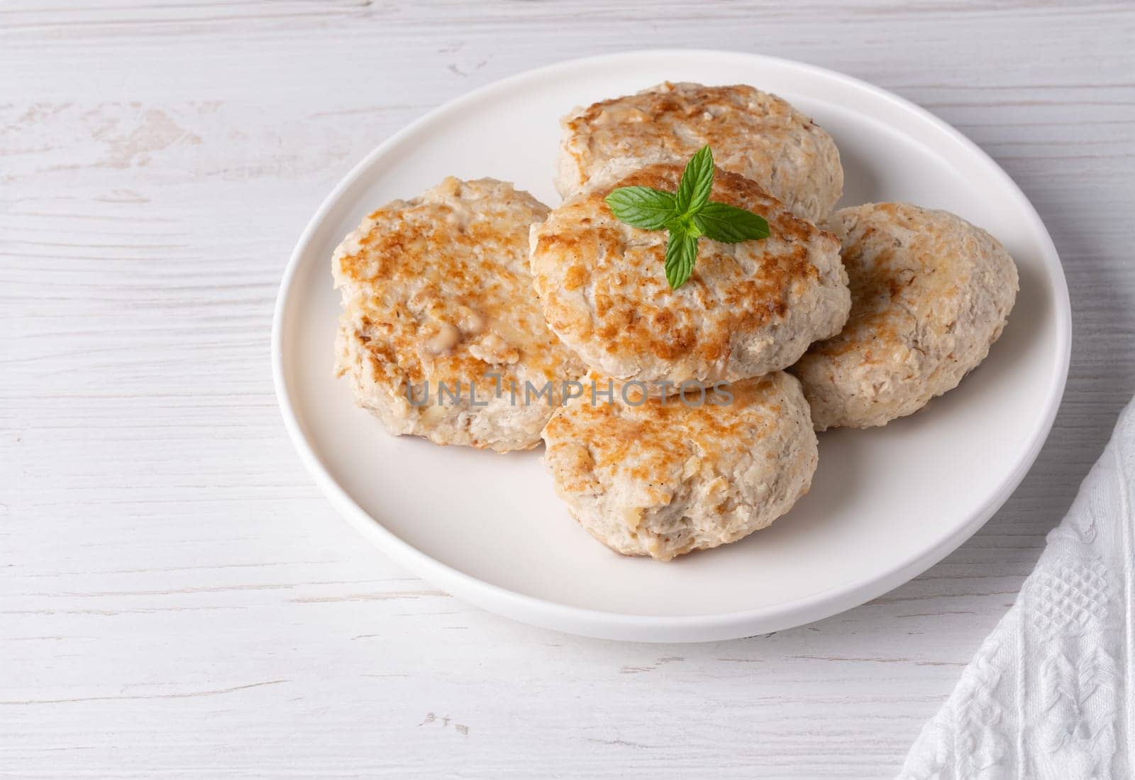 Roasted chicken cutlets on white plate.