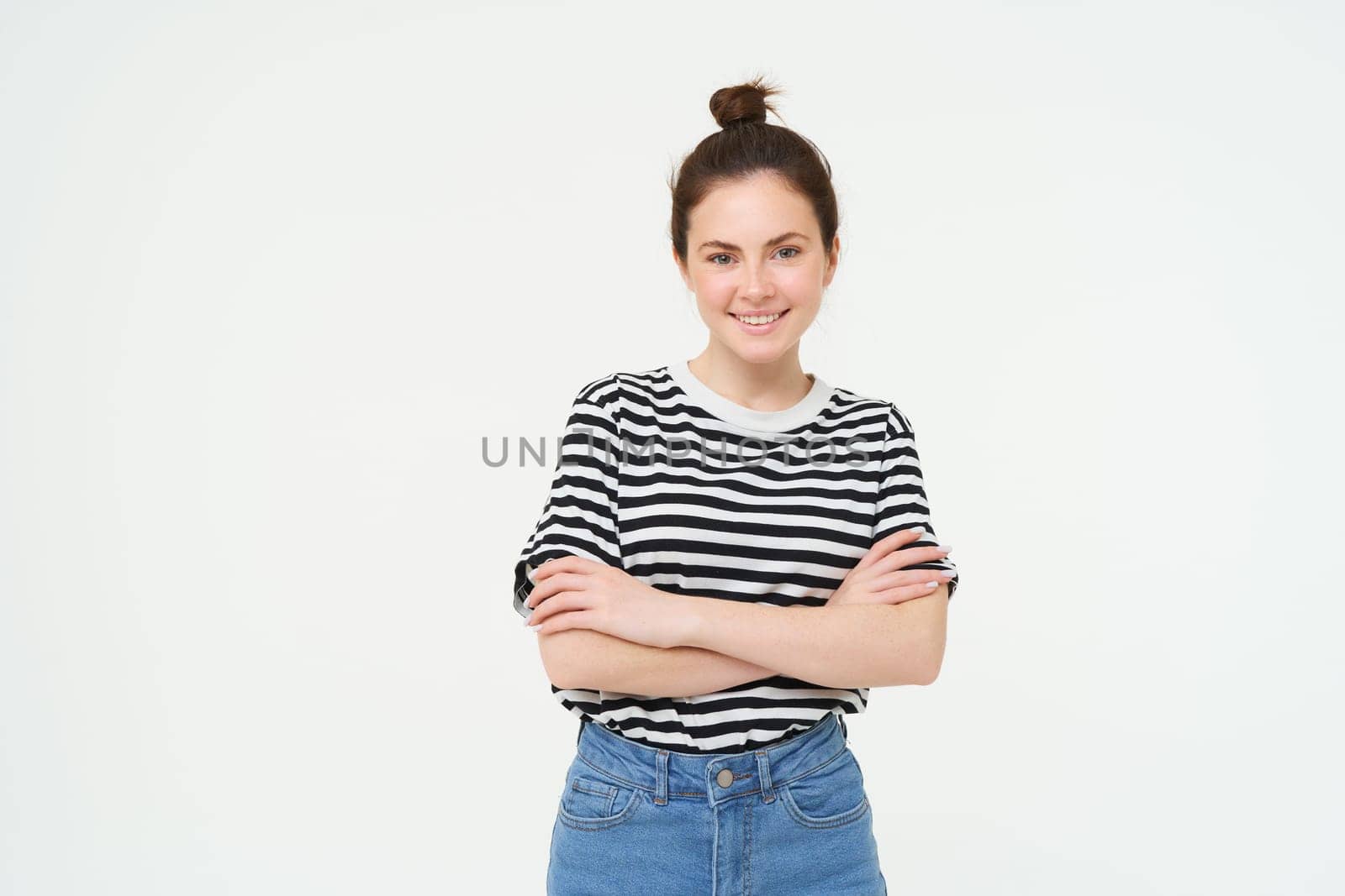 Portrait of attractive, stylish young woman, 25 years old, wearing t-shirt, cross arms against chest and smiling, looking confident, isolated over white background by Benzoix