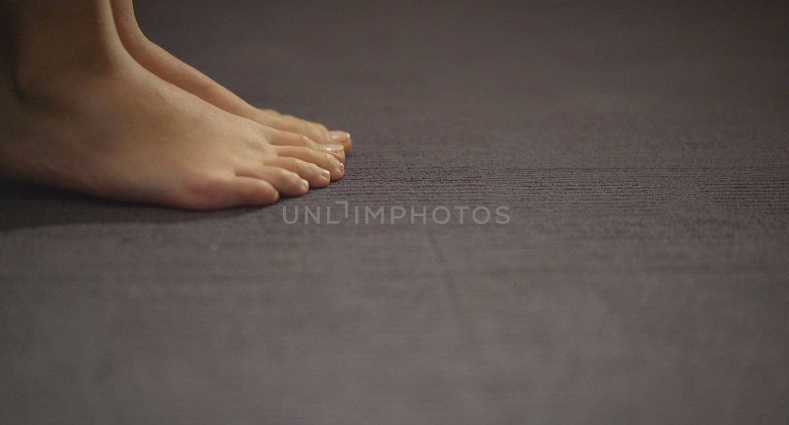 Beautiful womens feet. Beautiful legs on the gray floor. by Rusrussid
