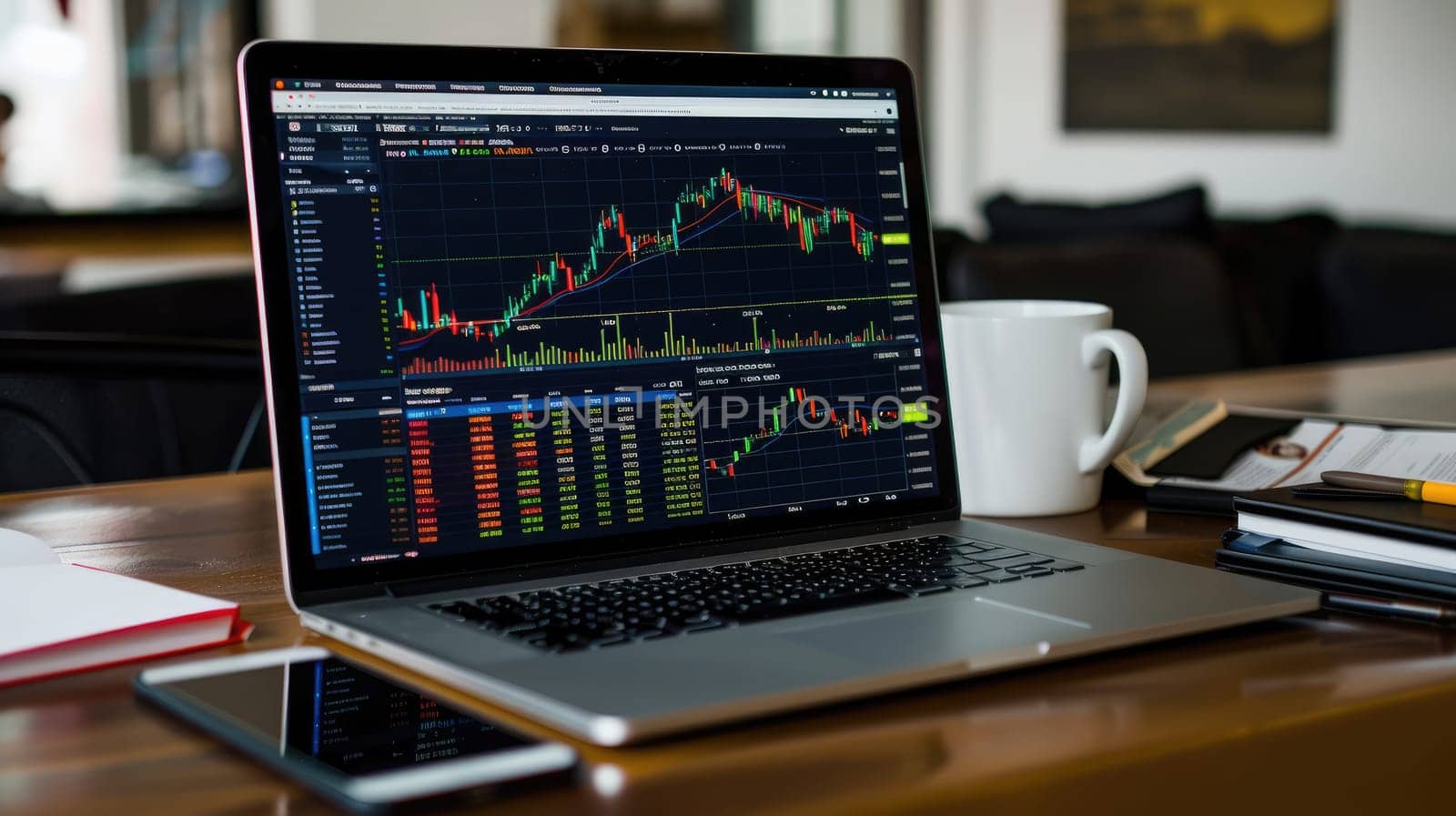 A laptop computer is open to a screen displaying a stock market graph.