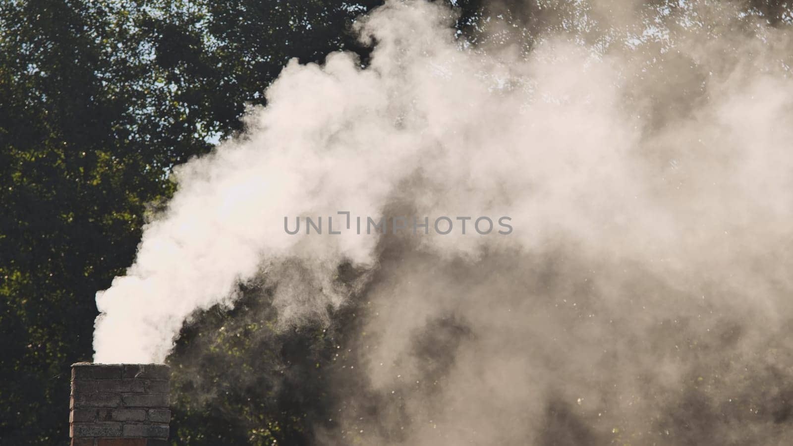 White smoke from the chimney of the village house. by DovidPro