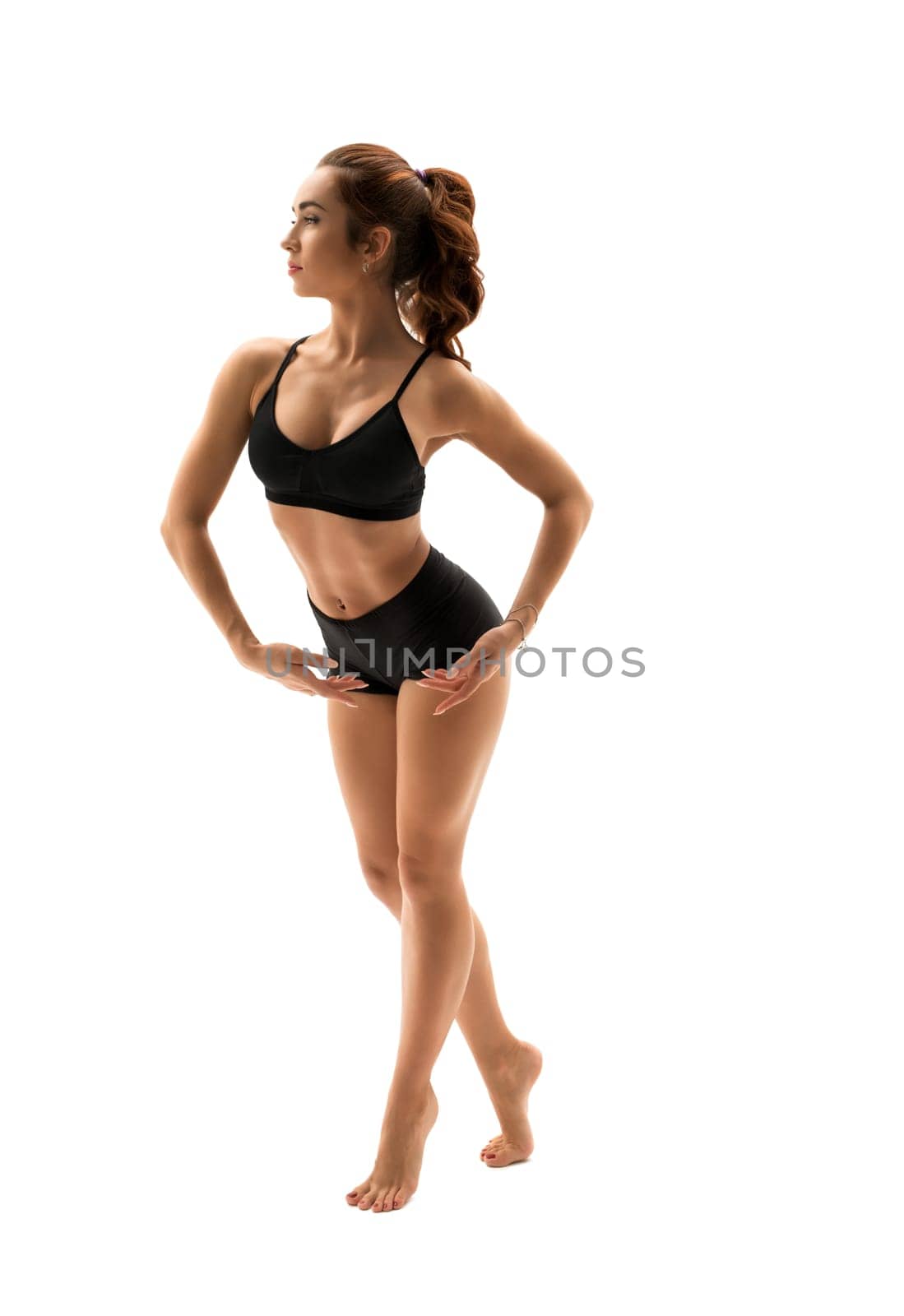 Beautiful dancer posing gracefully in studio by rivertime