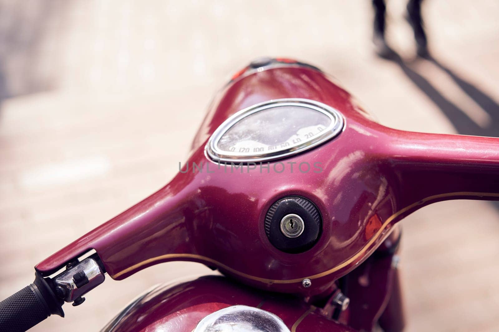 Vintage scooter handlebars on urban street in closeup, showcasing retro aesthetic and classic design