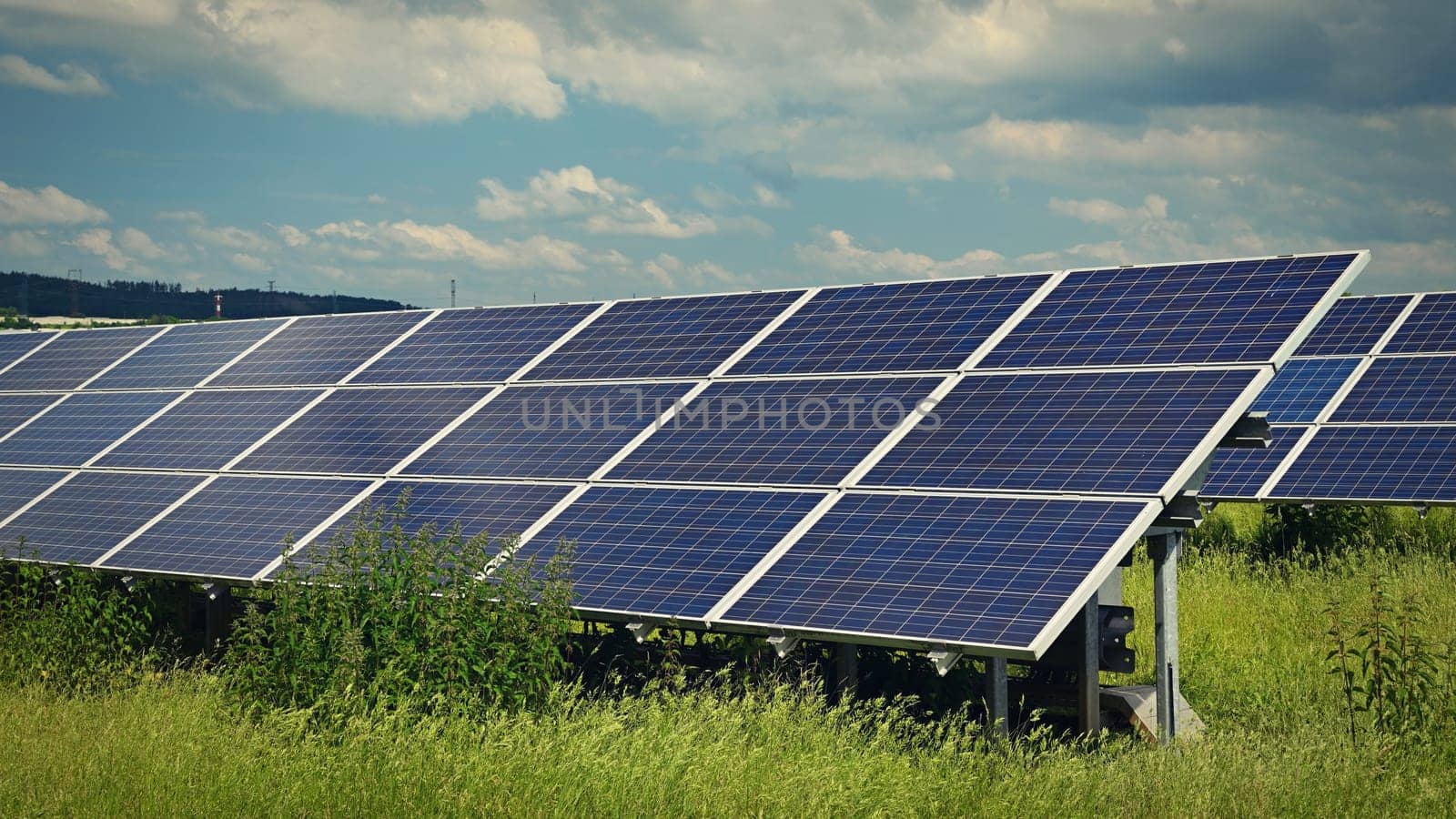 Solar power plant - concept for electricity and ecological industry. High energy prices. Beautiful landscape and sunny day with blue sky. Photovoltaic power plant. by Montypeter