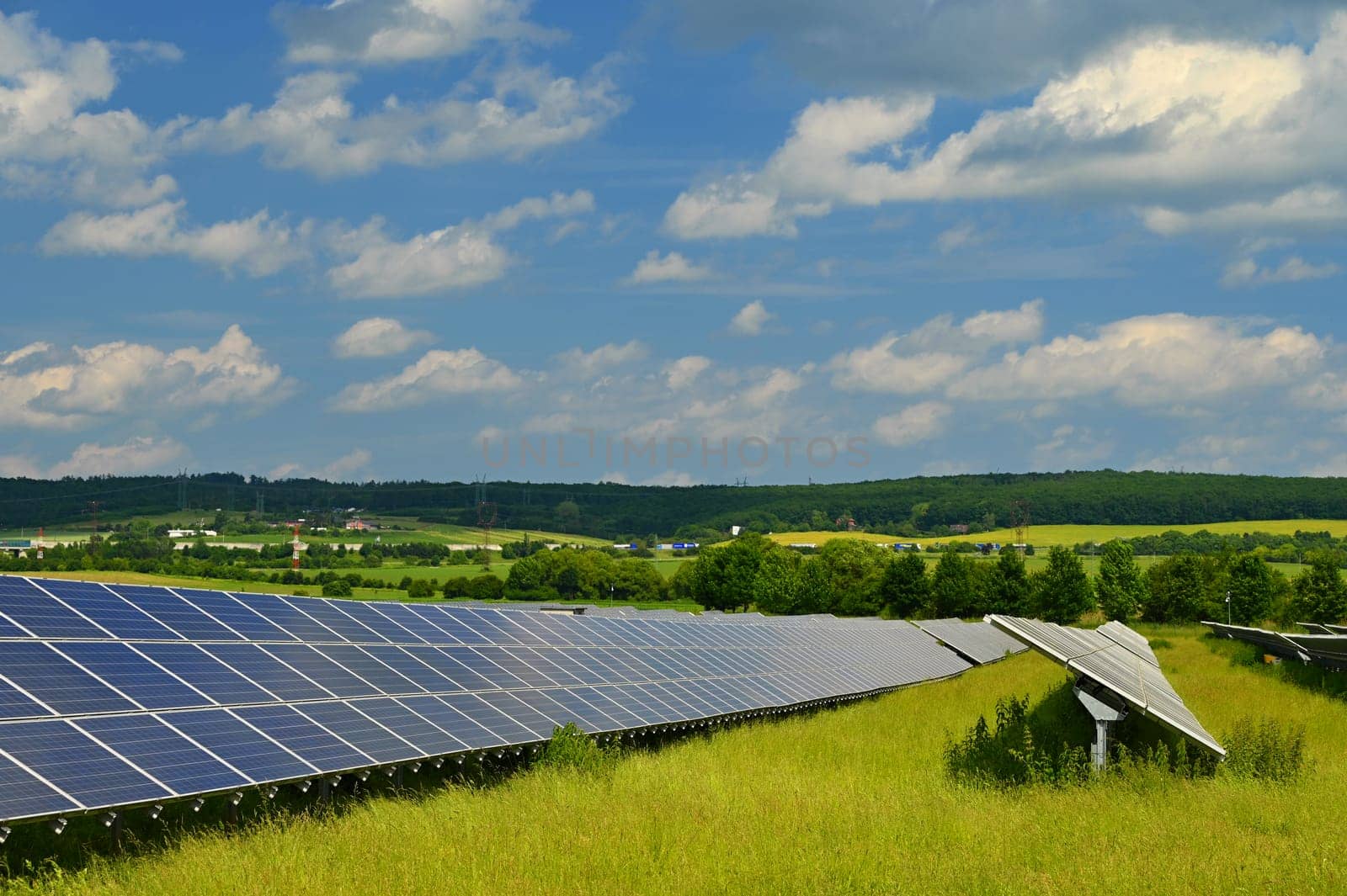 Solar power plant - concept for electricity and ecological industry. High energy prices. Beautiful landscape and sunny day with blue sky. Photovoltaic power plant. by Montypeter