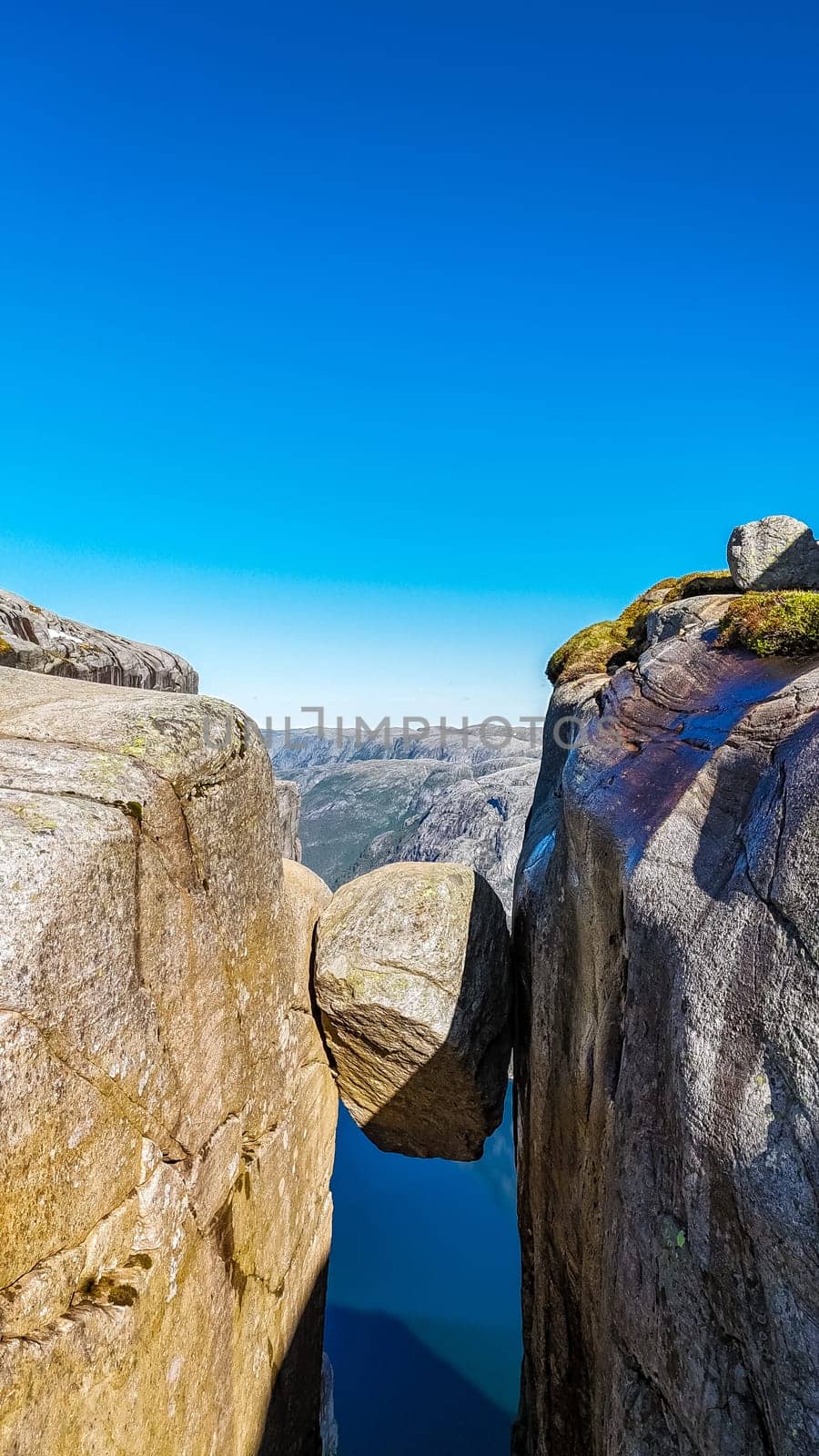 Kjeragbolten, Norway A large boulder precariously perched between two cliffs at the Pulpit Rock in Norway.