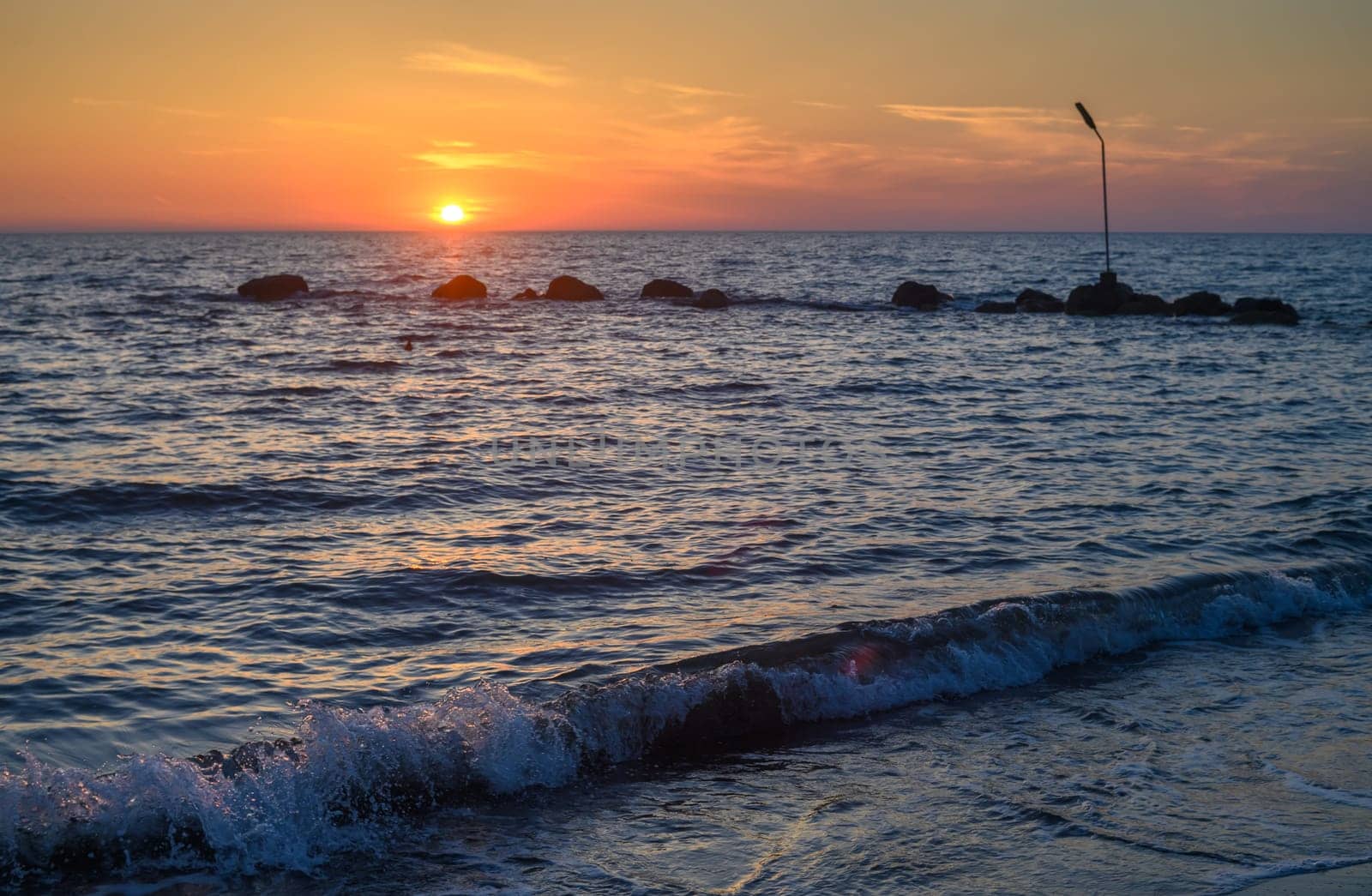 sea, clouds, mountains and waves on the Mediterranean coast on the island of Cyprus at sunset 4