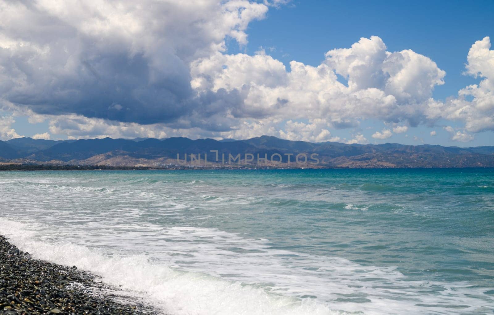 Mediterranean coast on the island of Cyprus on a sunny day, view of clouds and mountains by Mixa74