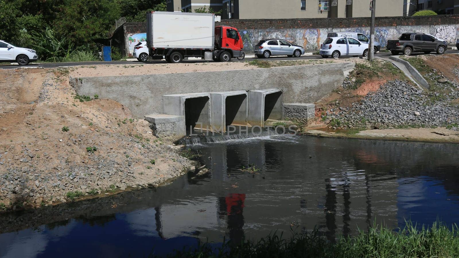 lauro de freitas, bahia, brazil - january 10, 2024: path of a pipeline with sewage water pouring into the Ipitanga River in the city of Lauro de Freitas.