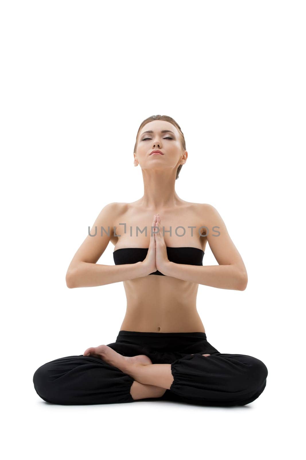 Pretty young woman meditating sitting in lotus position