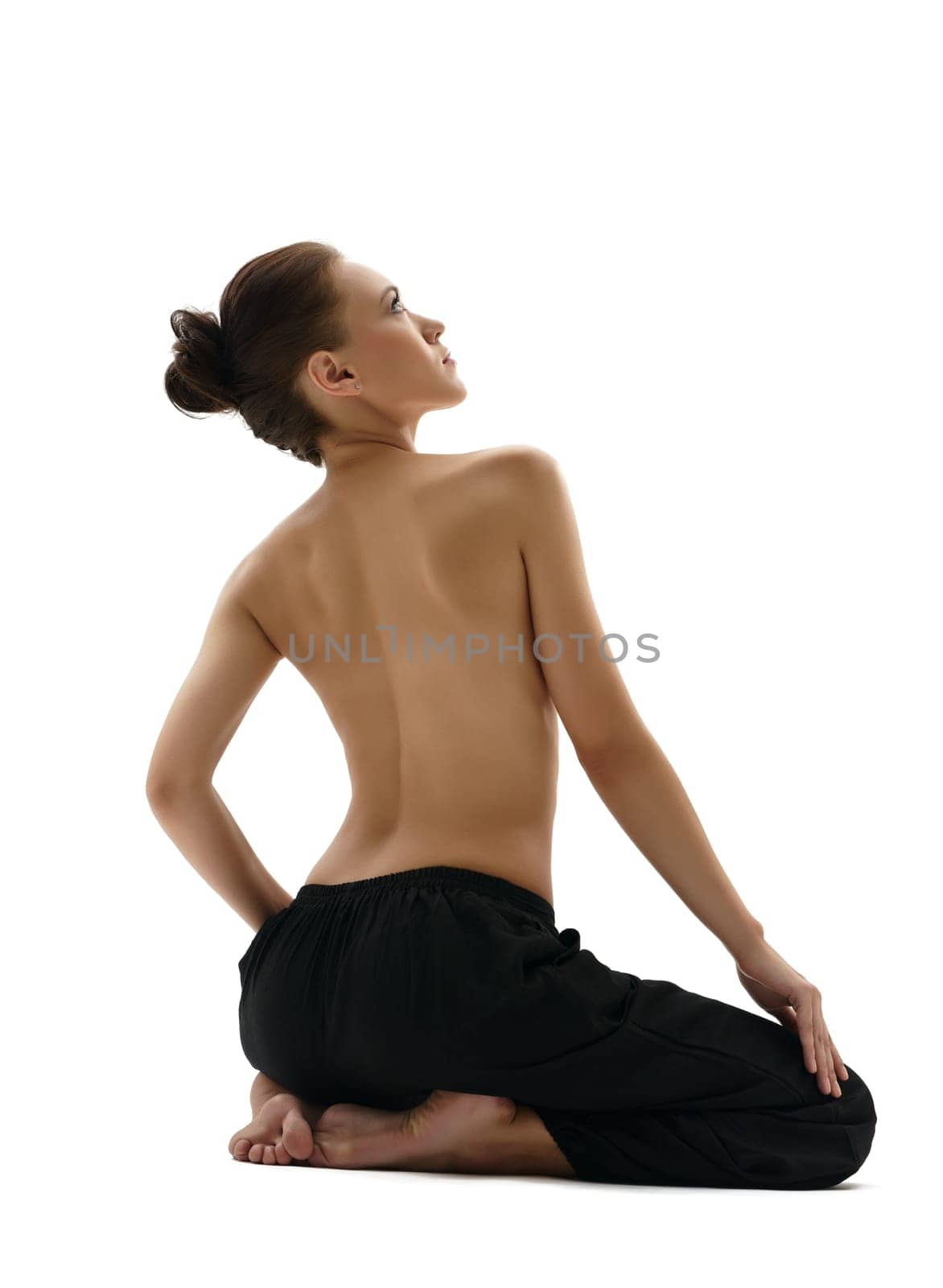 Topless young woman posing in wide trousers by rivertime