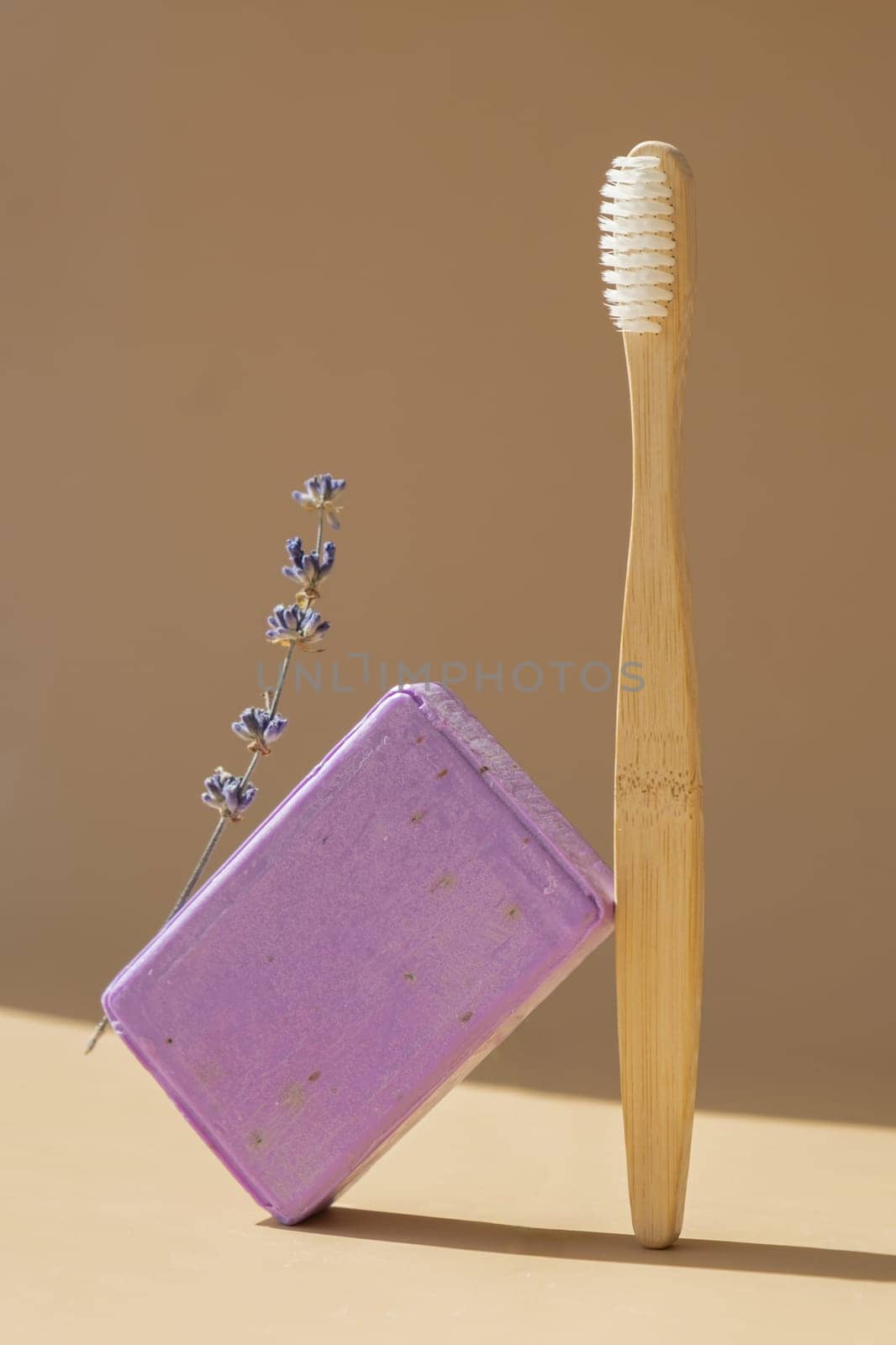 Eco friendly bamboo toothbrush and Handmade aromatic spa lavender soap. Natural additives and extracts. Bar of lavender soap with dried flowers. Beauty treatment product herbal ecological organic cosmetics. Copy space