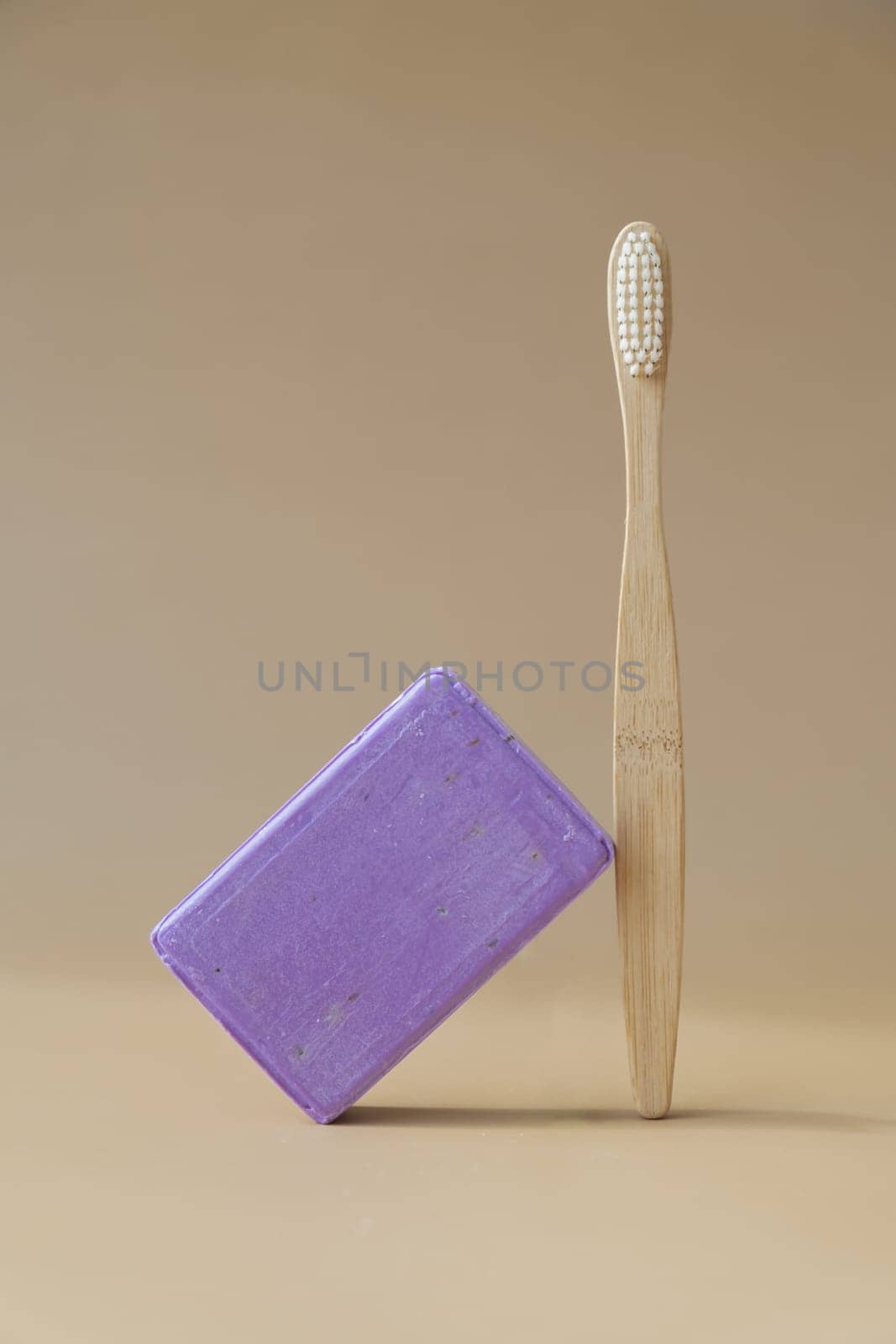 Zero waste bamboo toothbrush and Handcrafted purple lavender soap with lavender flowers. Natural hydrating moisturiser softness cosmetic. Organic calming beauty skincare product. Herbal self care wellness alternative soap. Copy space