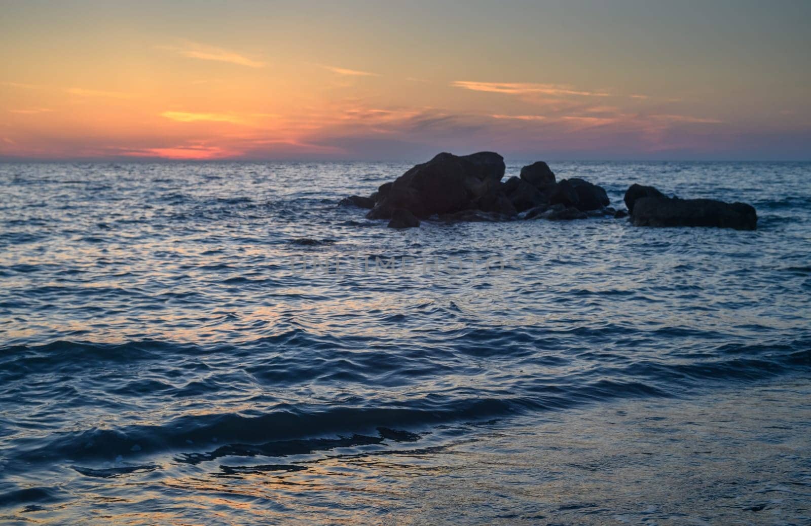 Rock stone stage in nature with sea beach seashore landscape and sunset summer sky by Mixa74