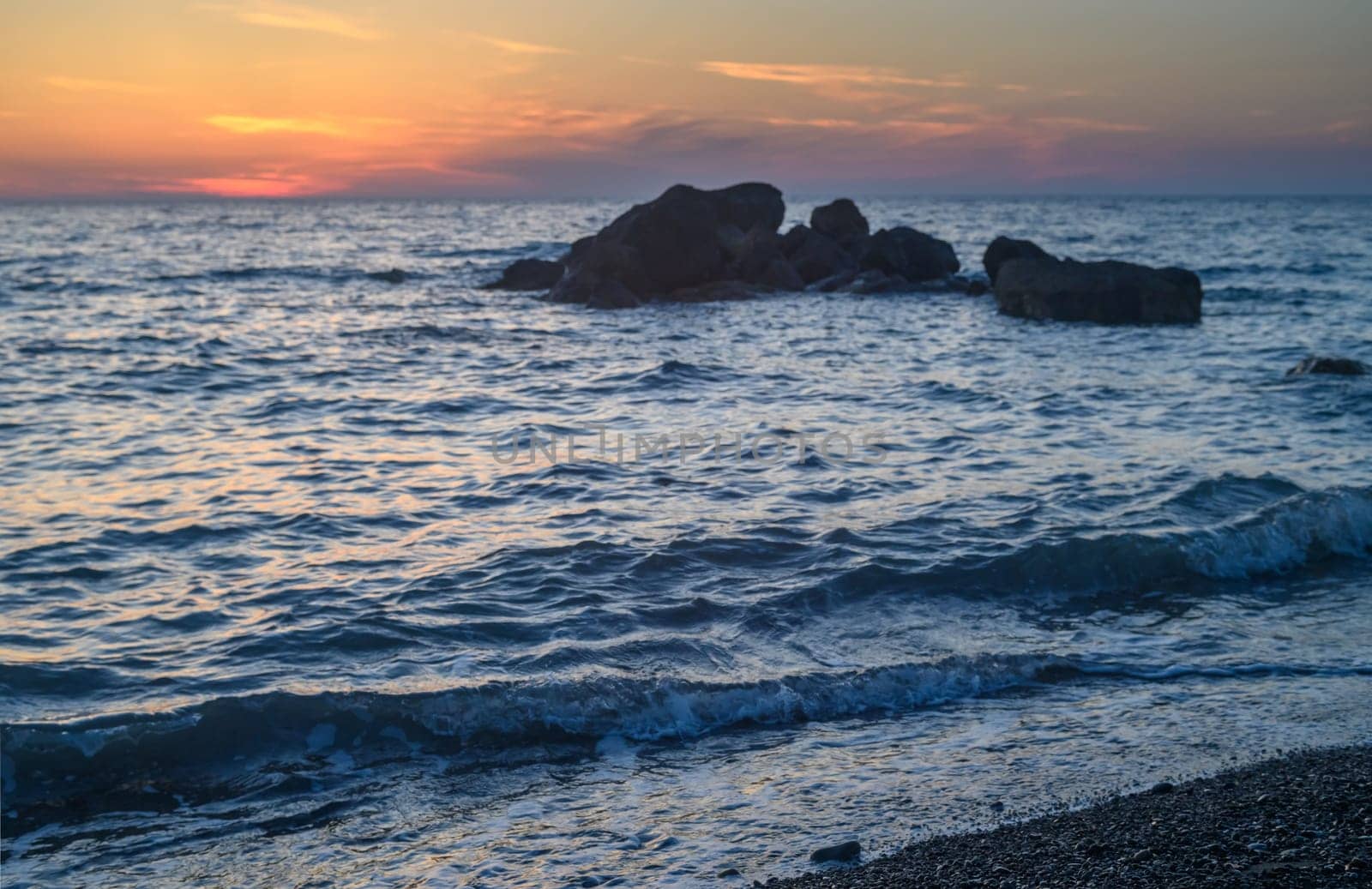 A stone in a calm sea at sunset by Mixa74