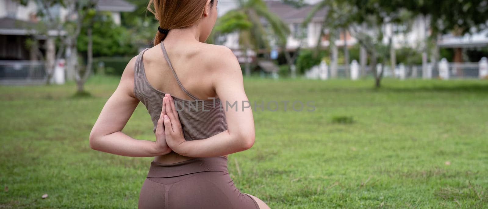 Woman Practice Yoga in Park. Healthy Lifestyle, Outdoor Fitness, Stretching Exercise, Wellness Activity, Peaceful Mindfulness, Natural Environment, Active Living, Back View, Tranquil Setting by nateemee