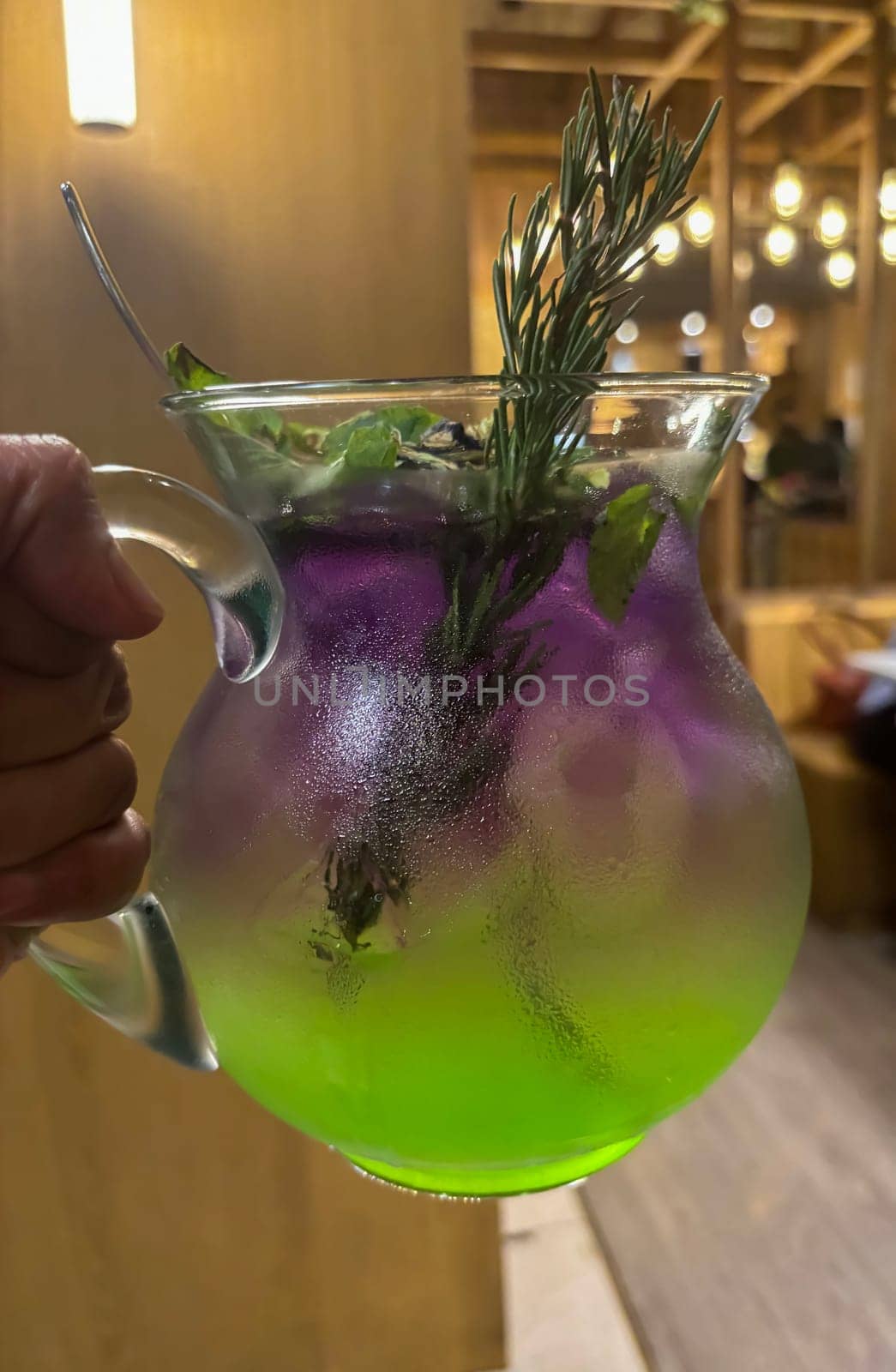 Two colored cocktail drink with blueberry and melon syrup taste in a pitcher served with herbs and mint leaves and ice cubes, good cocktail recipes good for drink content creation