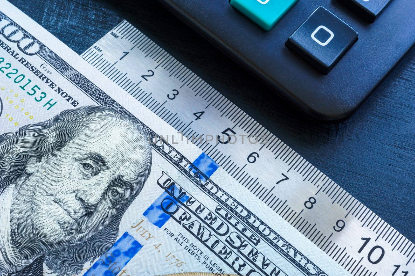 Money, ruler and a calculator. Performance based pay concept.