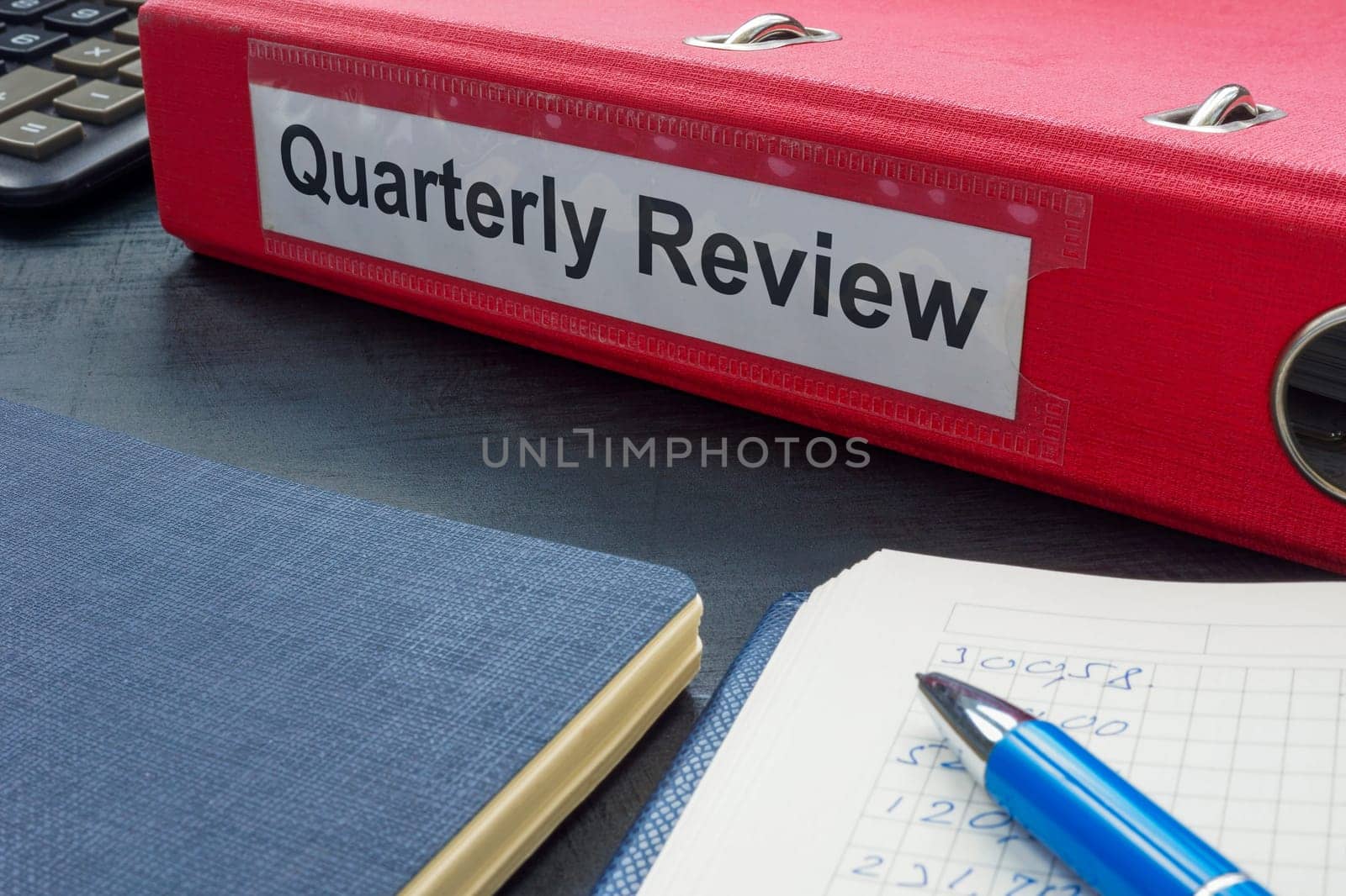A folder with label quarterly review and papers.